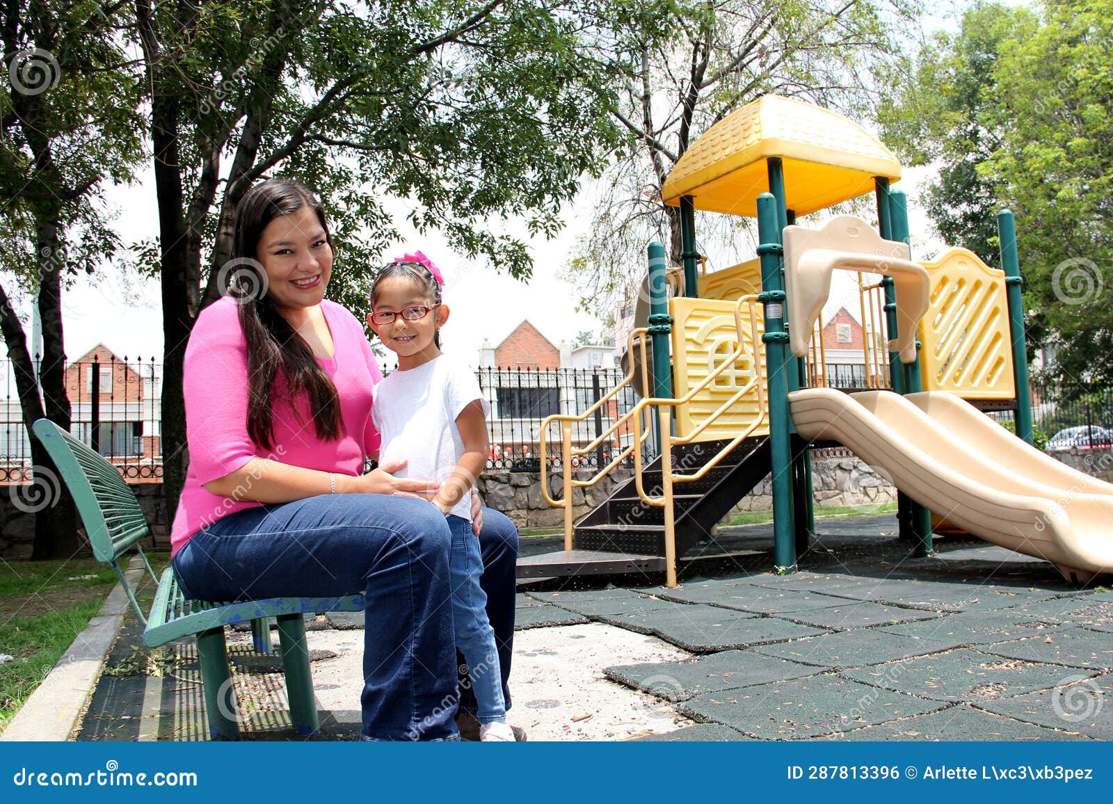 Latina Mom And 4 Year Old Daughter With Autism Spend Time Outdoors On A Park Bench To Calm