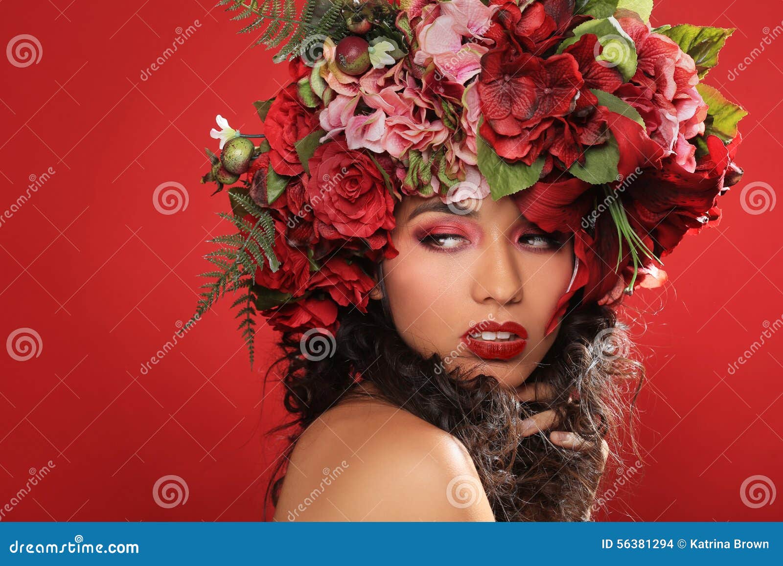 latina woman with floral headpiece on red