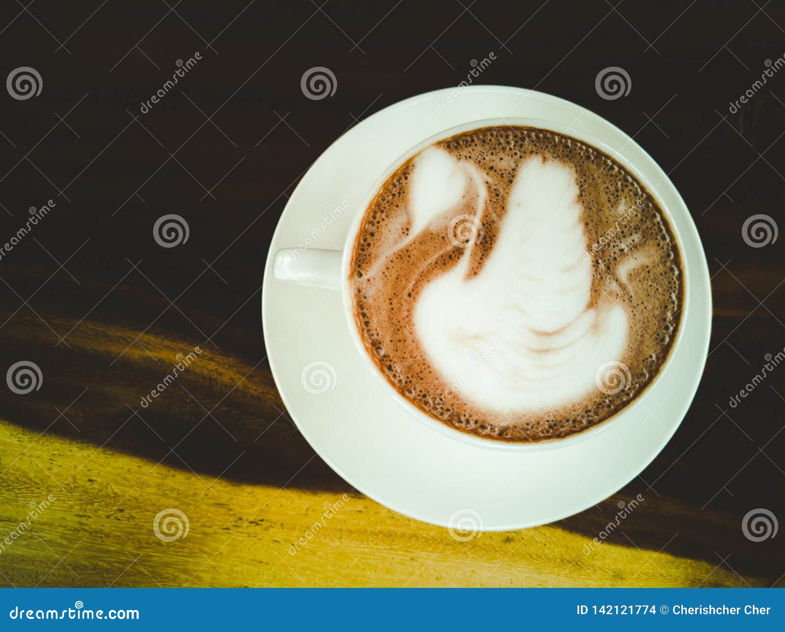 Latte Art, Swan Pattern on Hot Coffee in White Glass Stock Photo