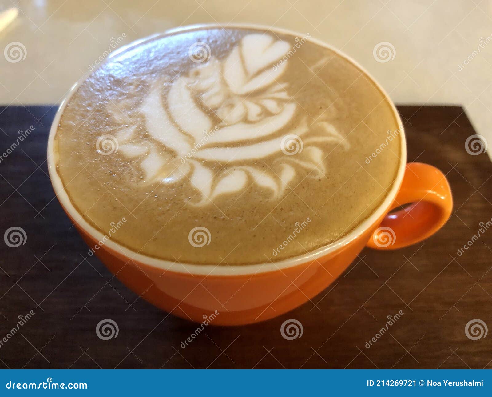 latte art. top view. orange coffee cup