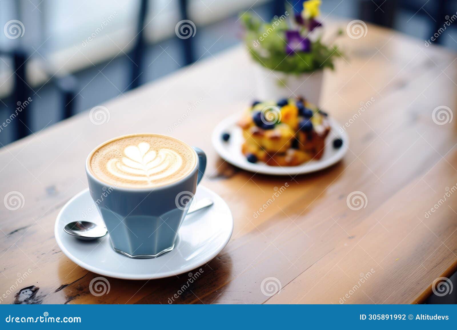 latte with blueberry muffin on a caf table