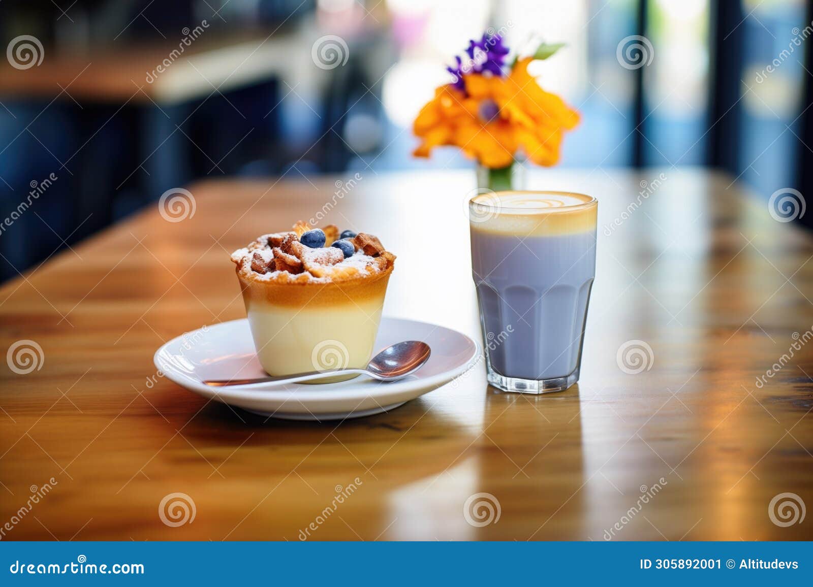 latte with blueberry muffin on a caf table