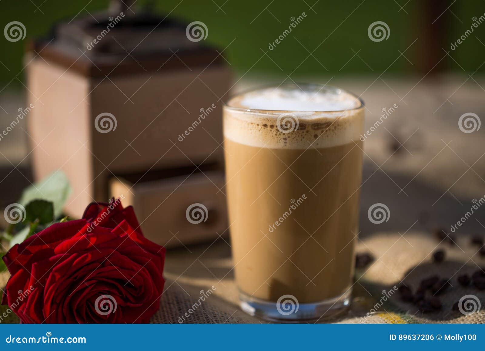 Latte Macchiato with Red Rose and Coffee Mill in the Background Stock ...