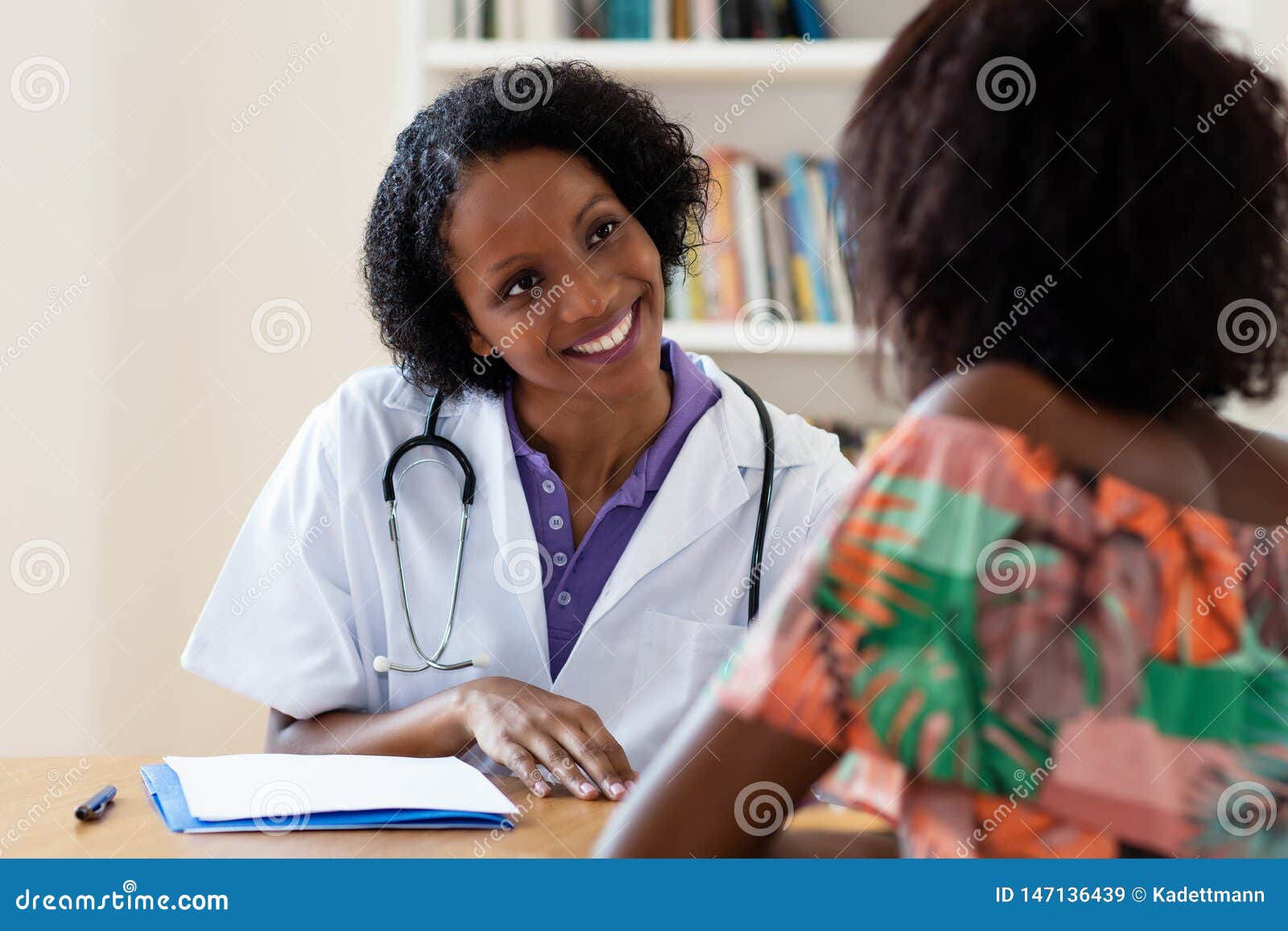 laughing african american female doctor with patient