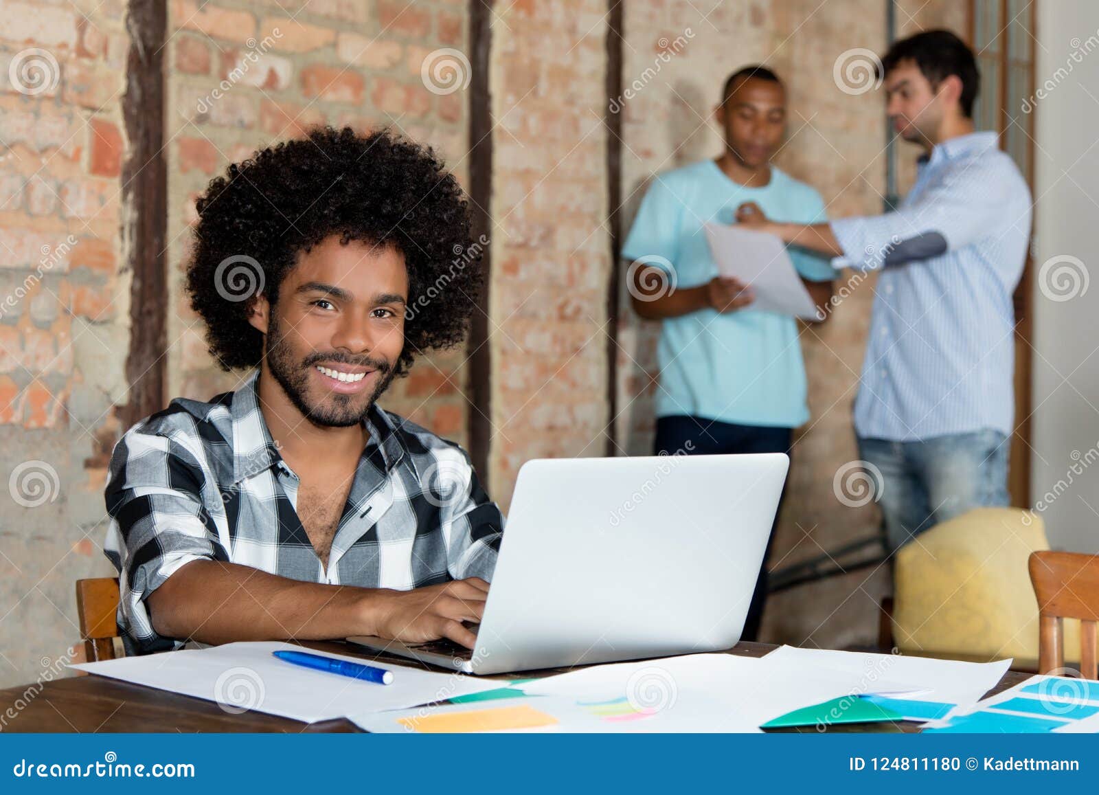laughing african american hipster software developer at computer
