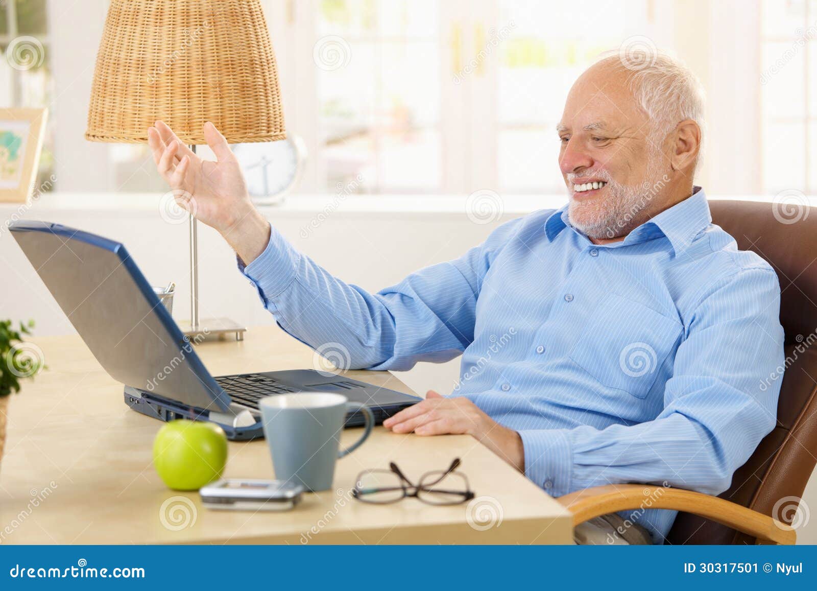 laughing-old-man-using-laptop-computer-home-looking-screen-gesturing-30317501.jpg