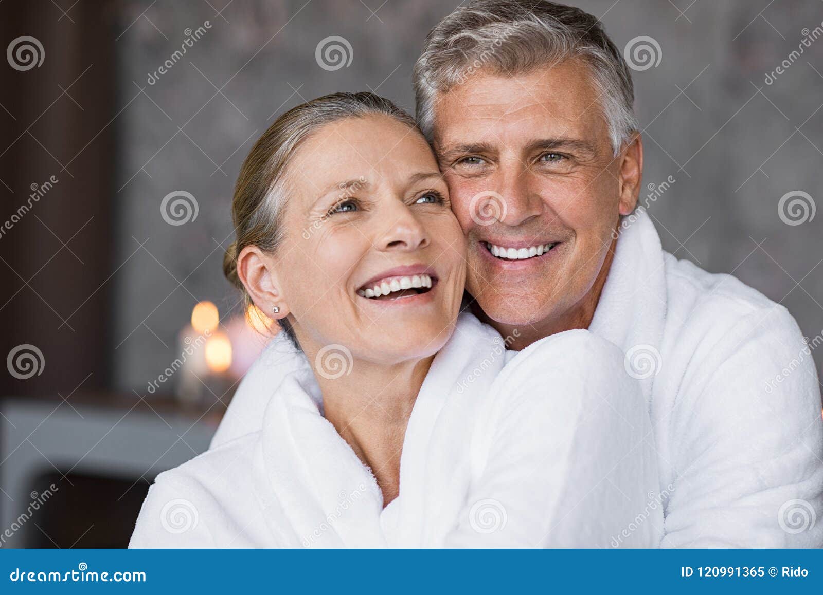 laughing senior couple embracing at spa
