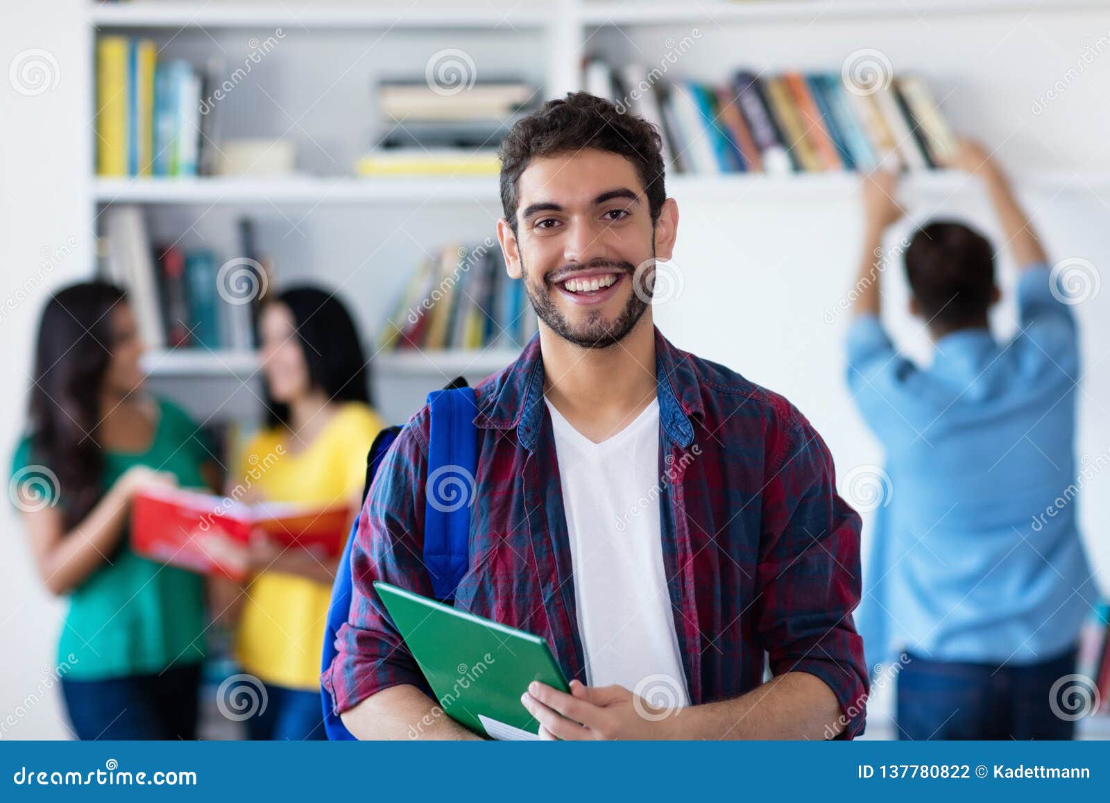 laughing spanish male student with group of students