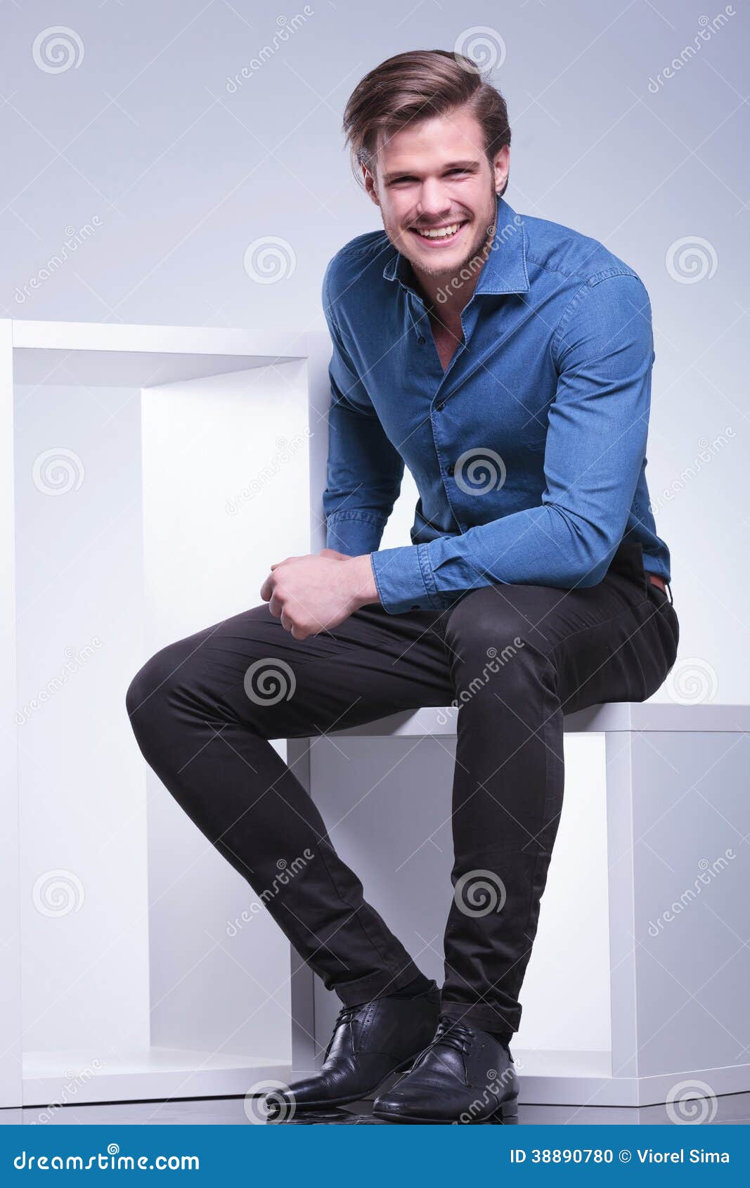 Laughing Young Casual Man is Sitting in Studio Stock Photo - Image of ...