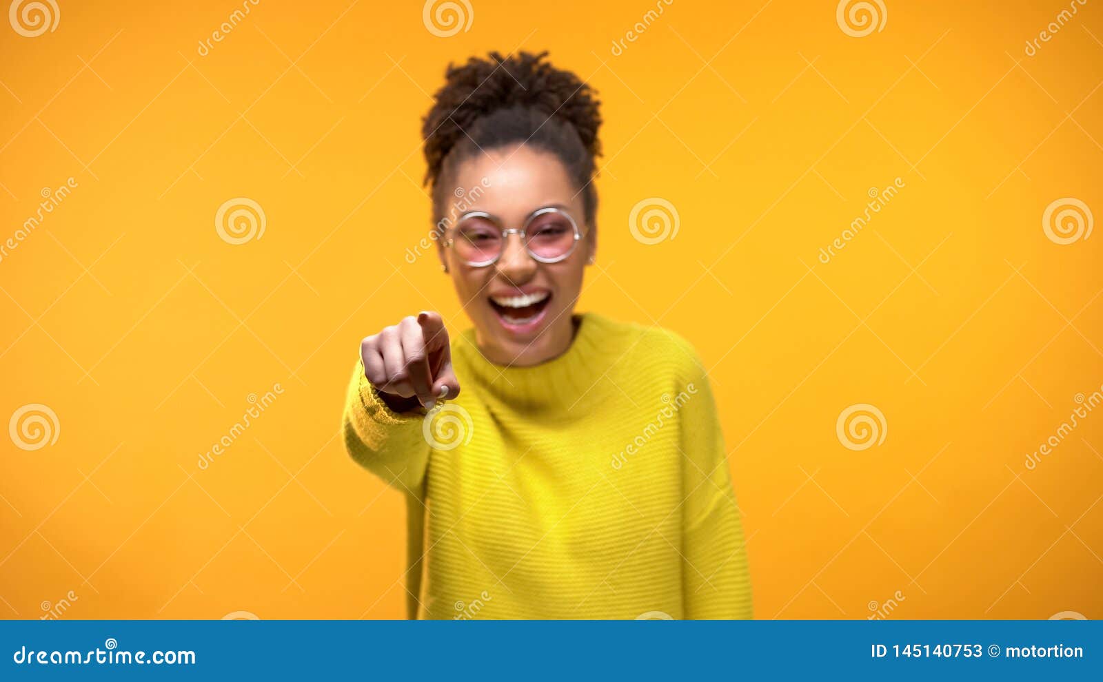 laughing young female pointing finger in camera, having fun, joking, positivity