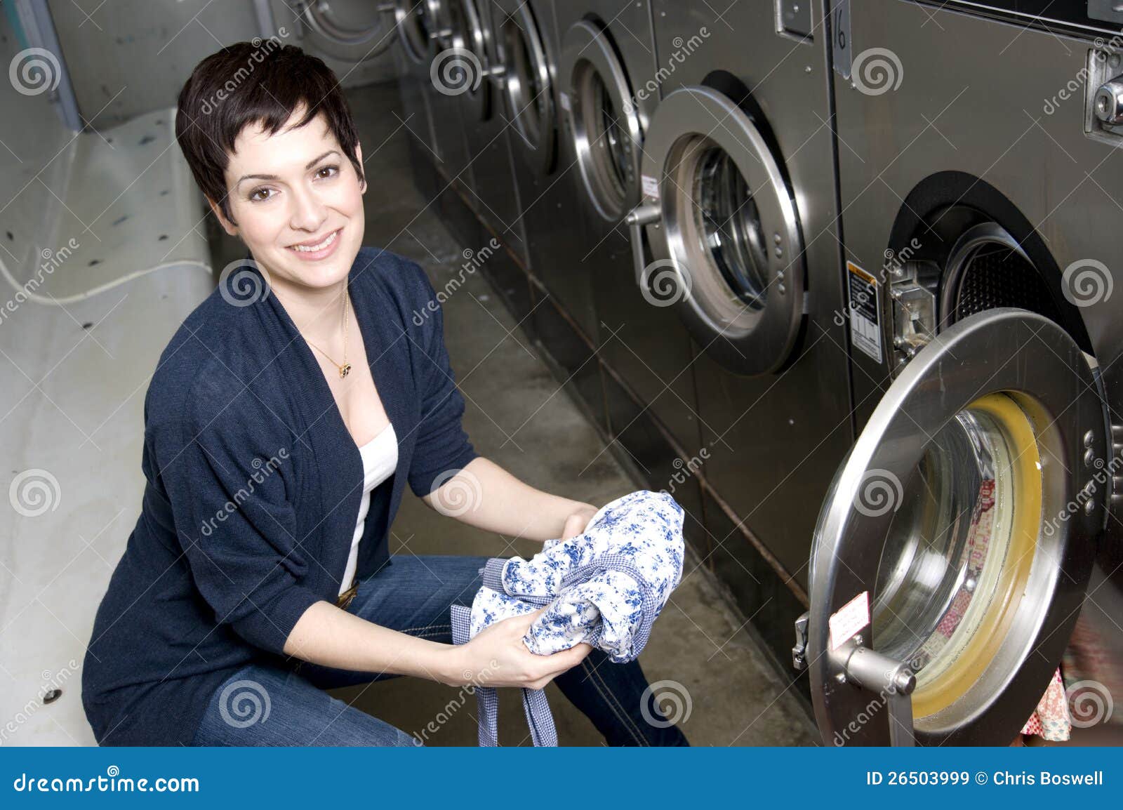 laundry day woman folds clothes laundromat