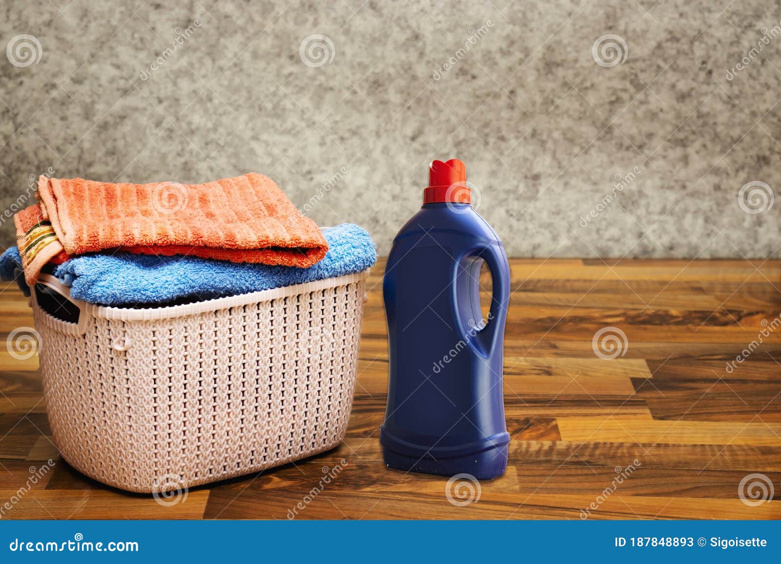 Laundry Detergent Bottle and Basket Stack of Clean Bath Towels on Floor