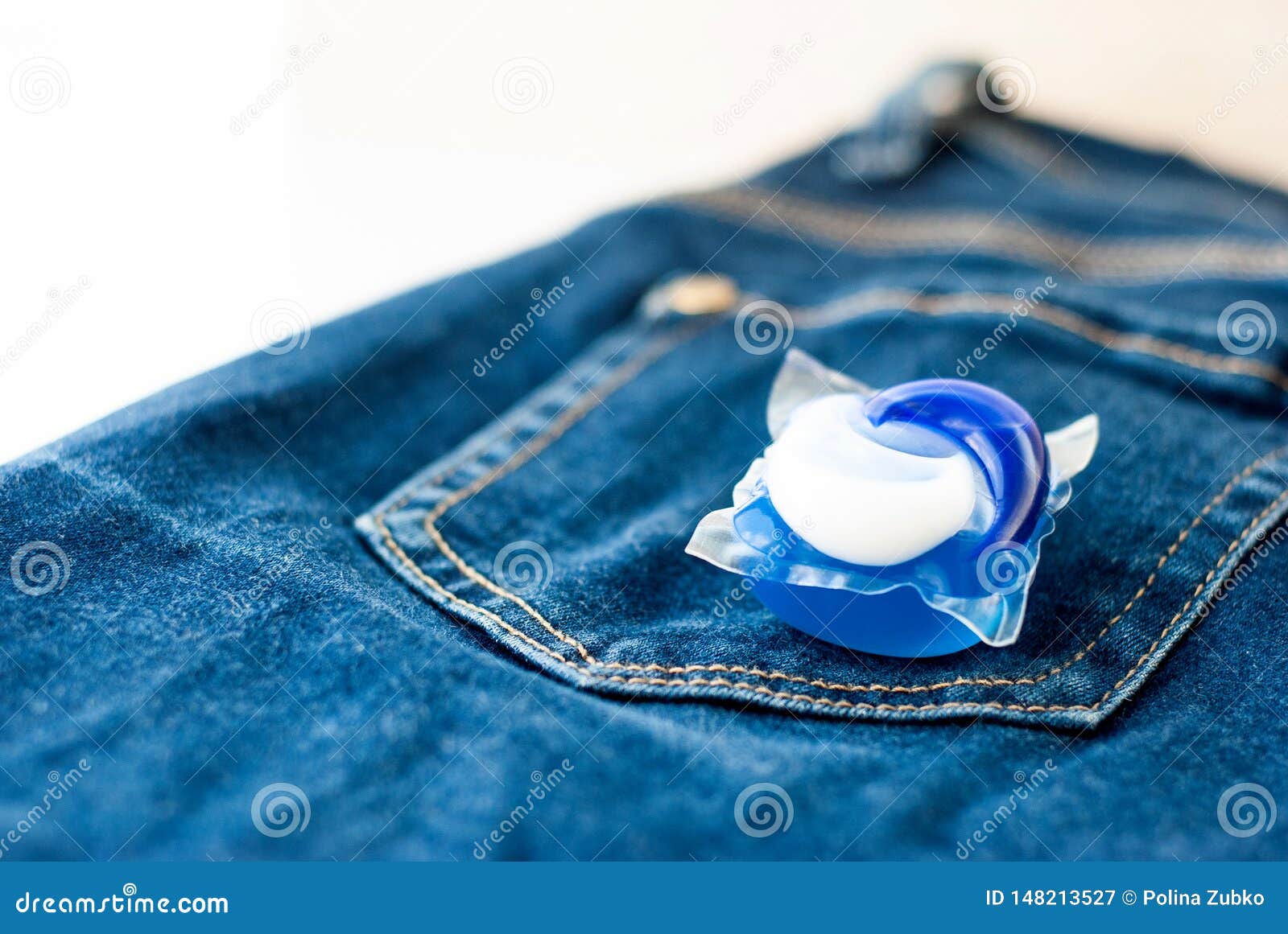 Laundry and Detergent Capsule Pod on Jeans Stock Image Image of