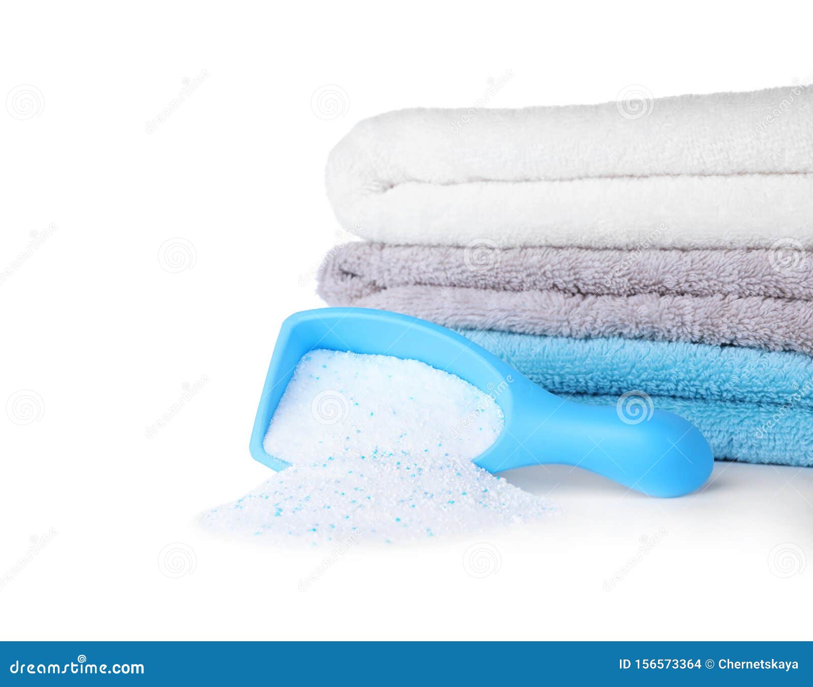 Laundry Detergent in Plastic Measuring Scoop and Towels Stock Photo