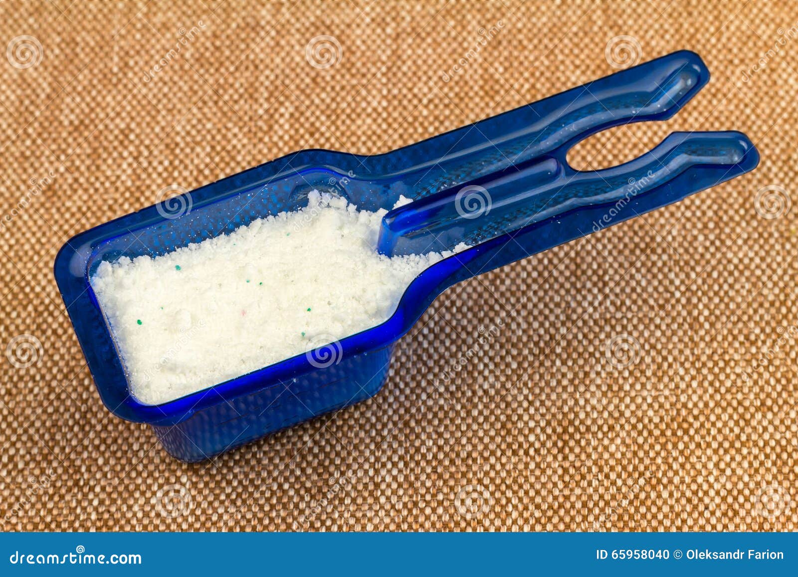Laundry Detergent or Washing Powder in Blue Measuring Cup, Top View