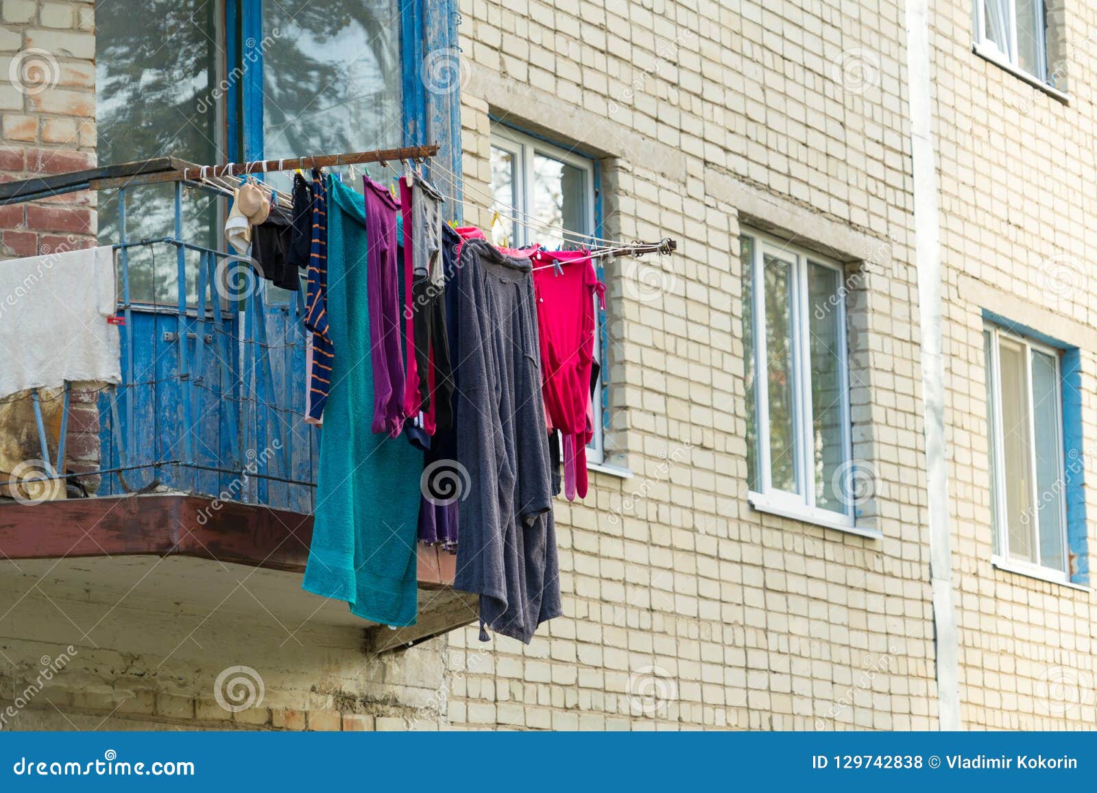 Laundry Dried Outside the Window. Balcony with Clothes Dryer. Stock
