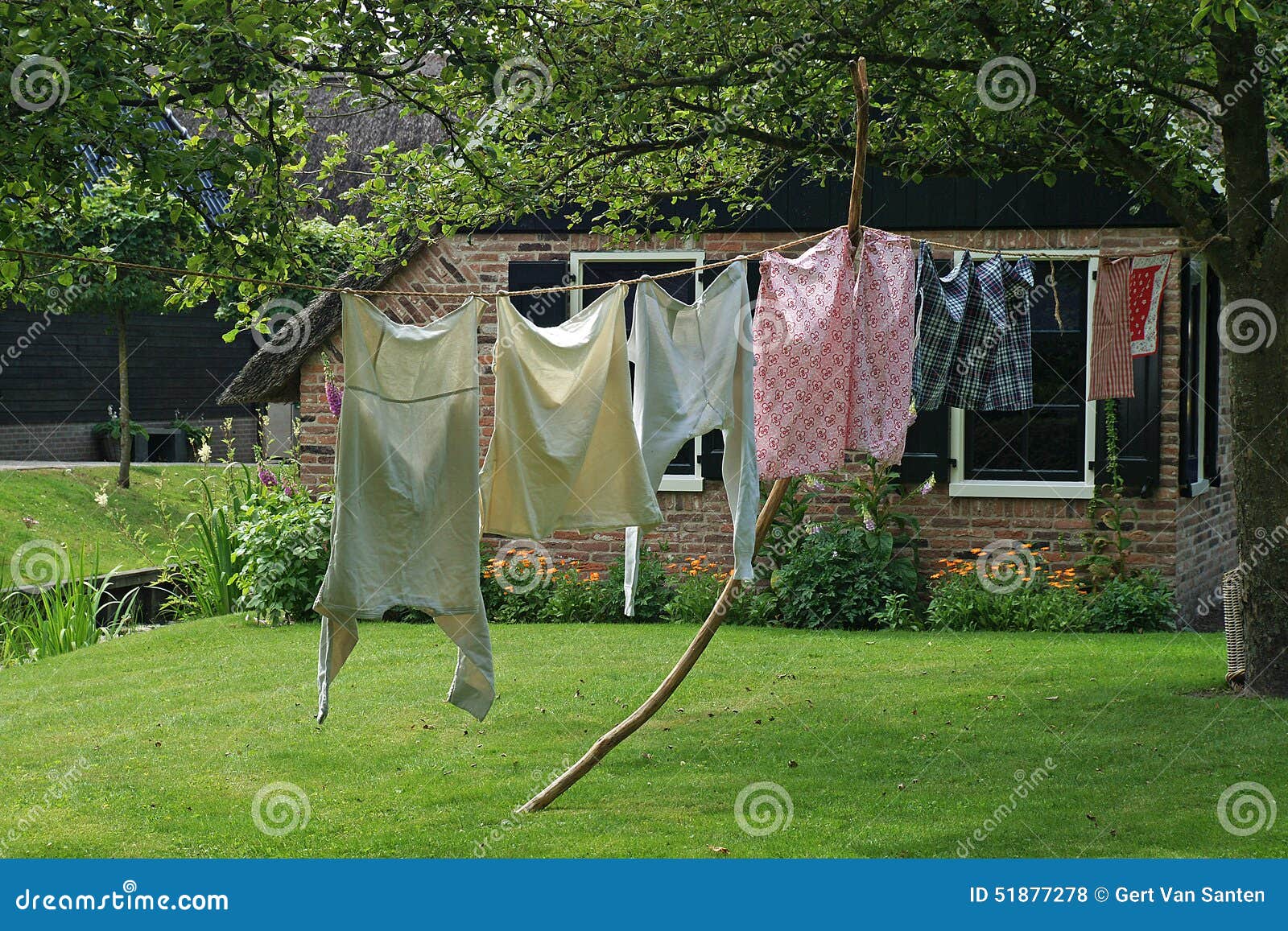 Laundry is Drying at a Line Outside Near the Farmhouse Stock Photo - Image  of clothespin, leaves: 51877278