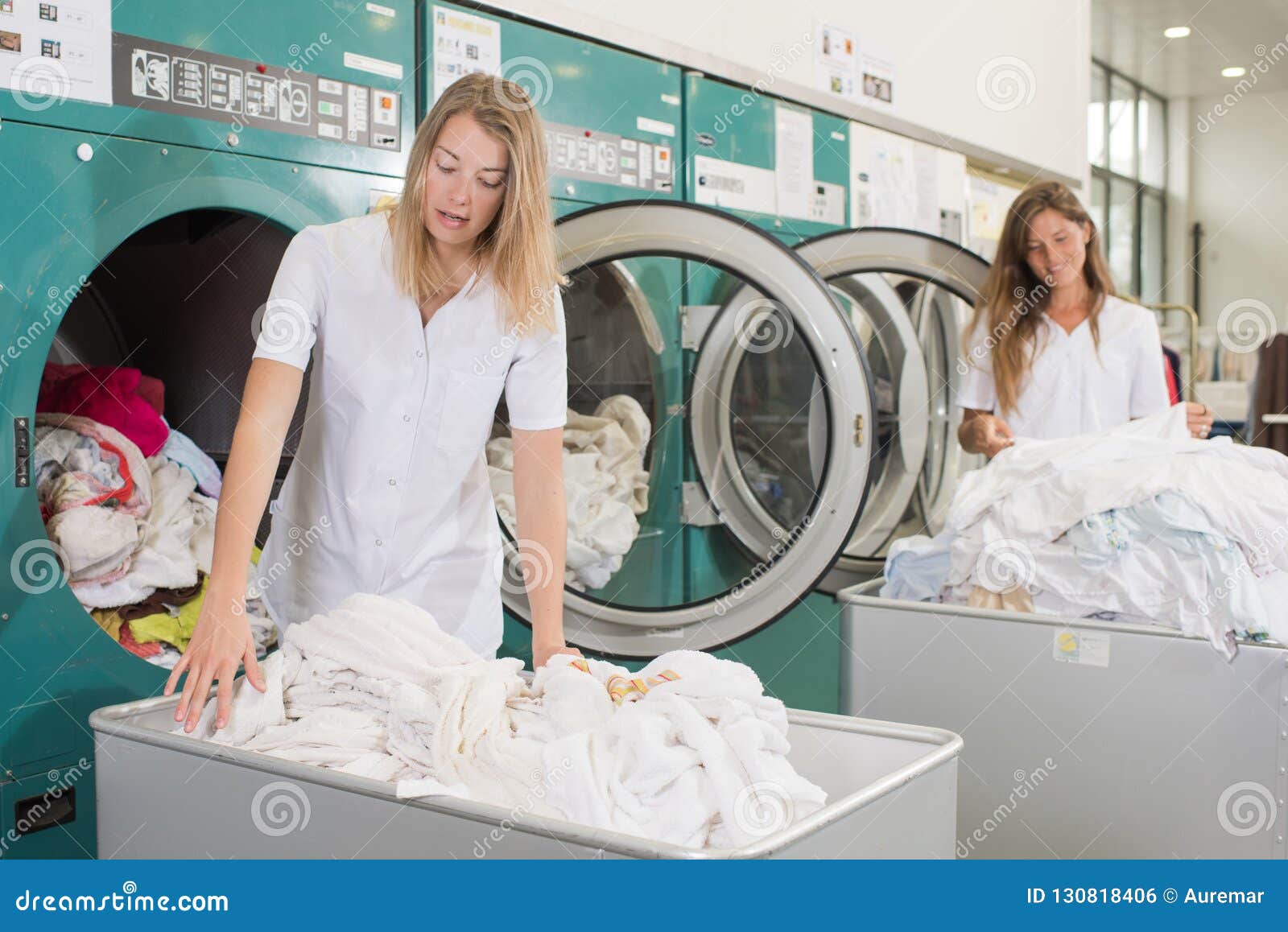 Laundry employees at work stock photo. Image of colleague 130818406