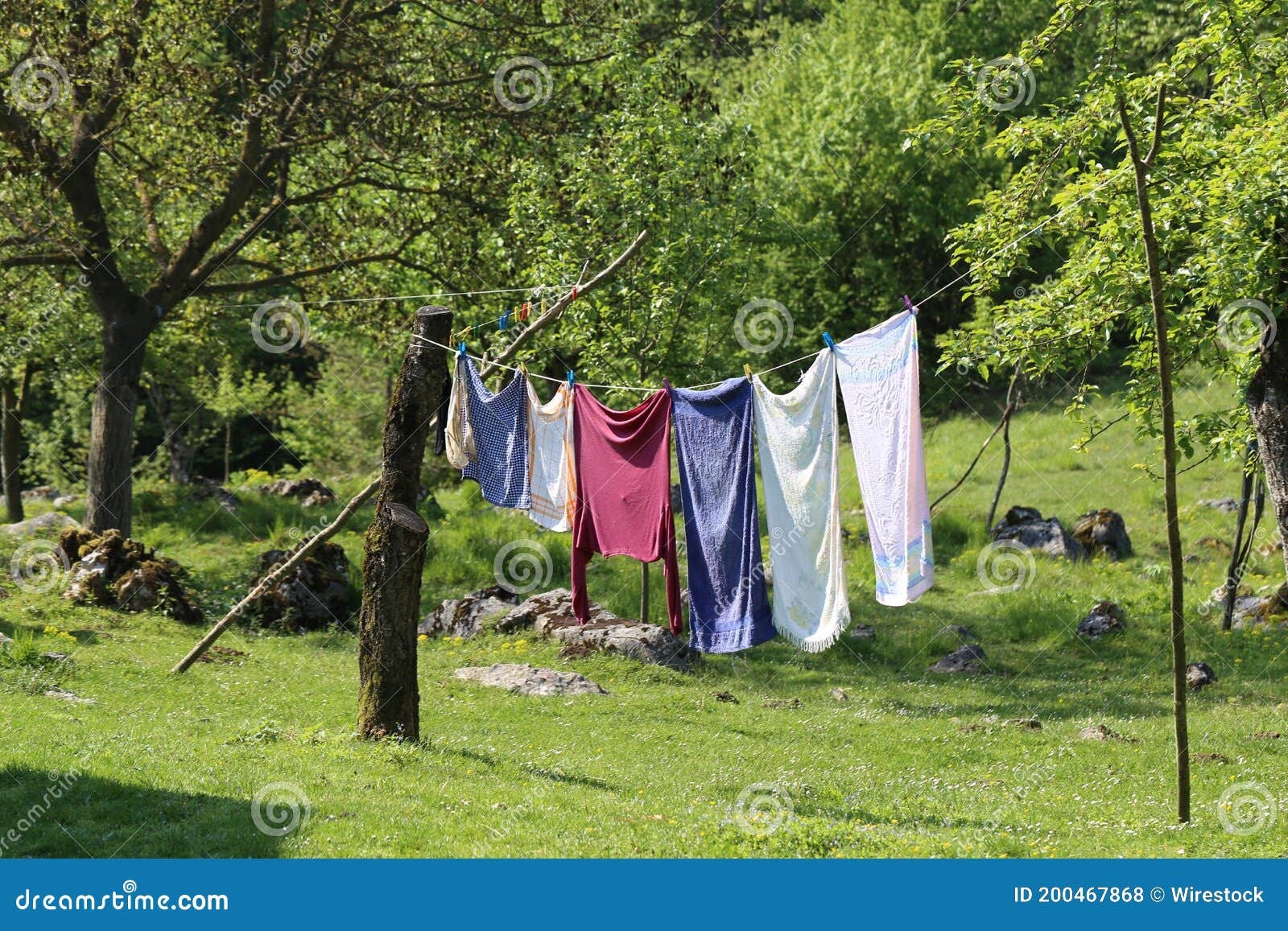 Laundry Hanging on a Rope and Drying in the Backyard of a House Stock