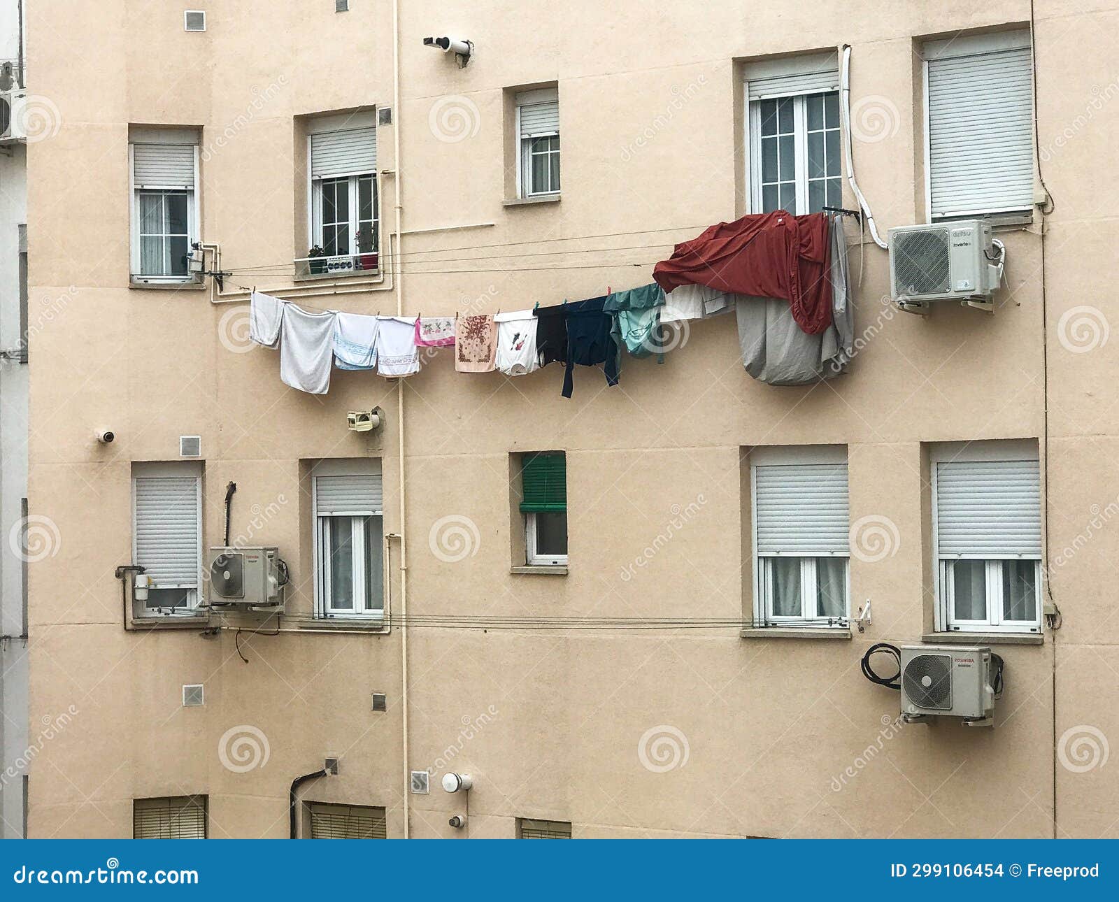 Laundry Hanging from a Thread in the Window of a Building in a District
