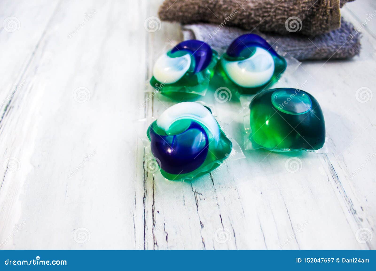 Laundry Pods with Tan and Gray Washcloths Stock Image Image of table