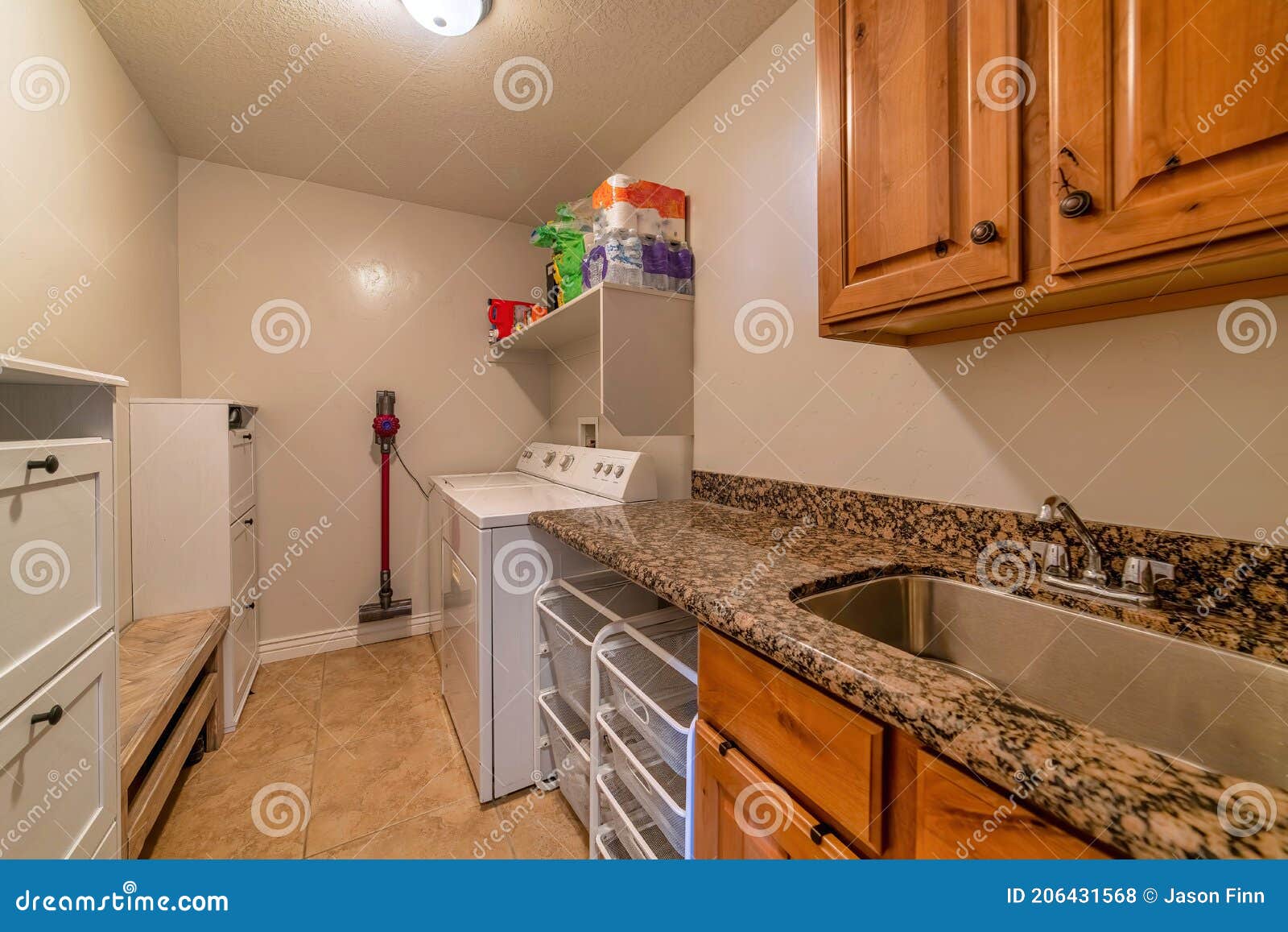 Laundry Room of Home with Sink Washing Machine Dryer Cabinets and
