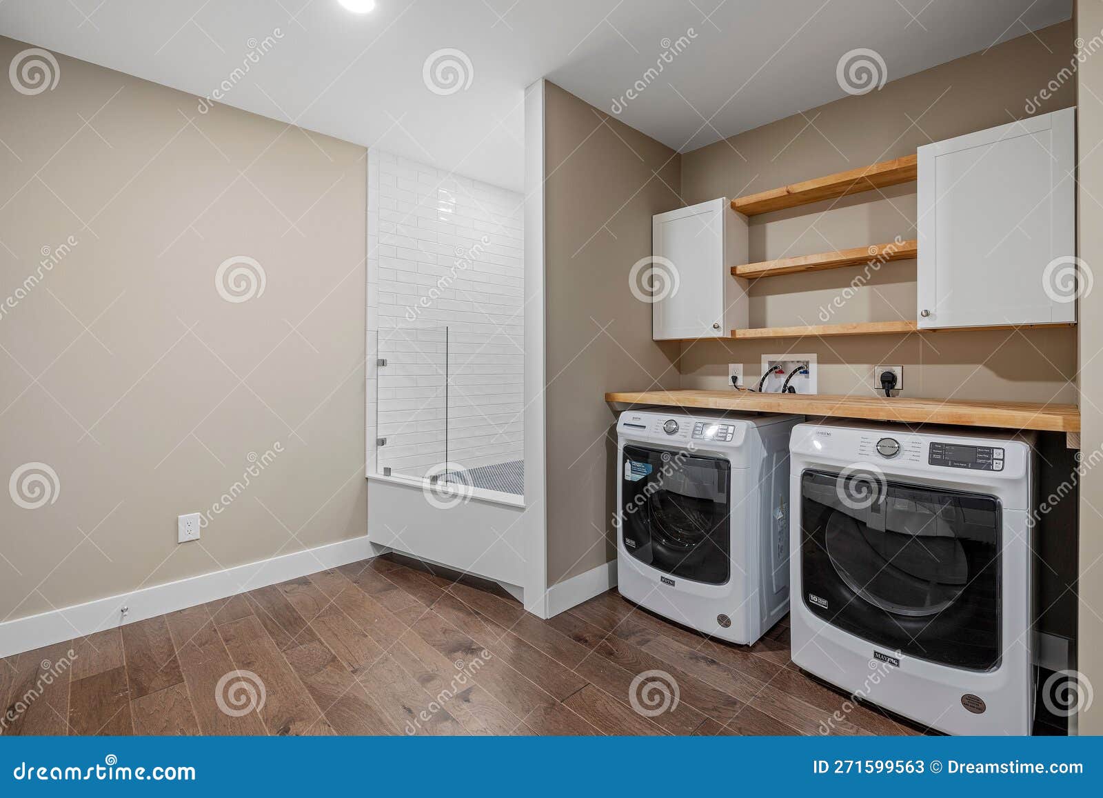 Laundry Room with a Washer and Dryer Combo in the Center Stock Image