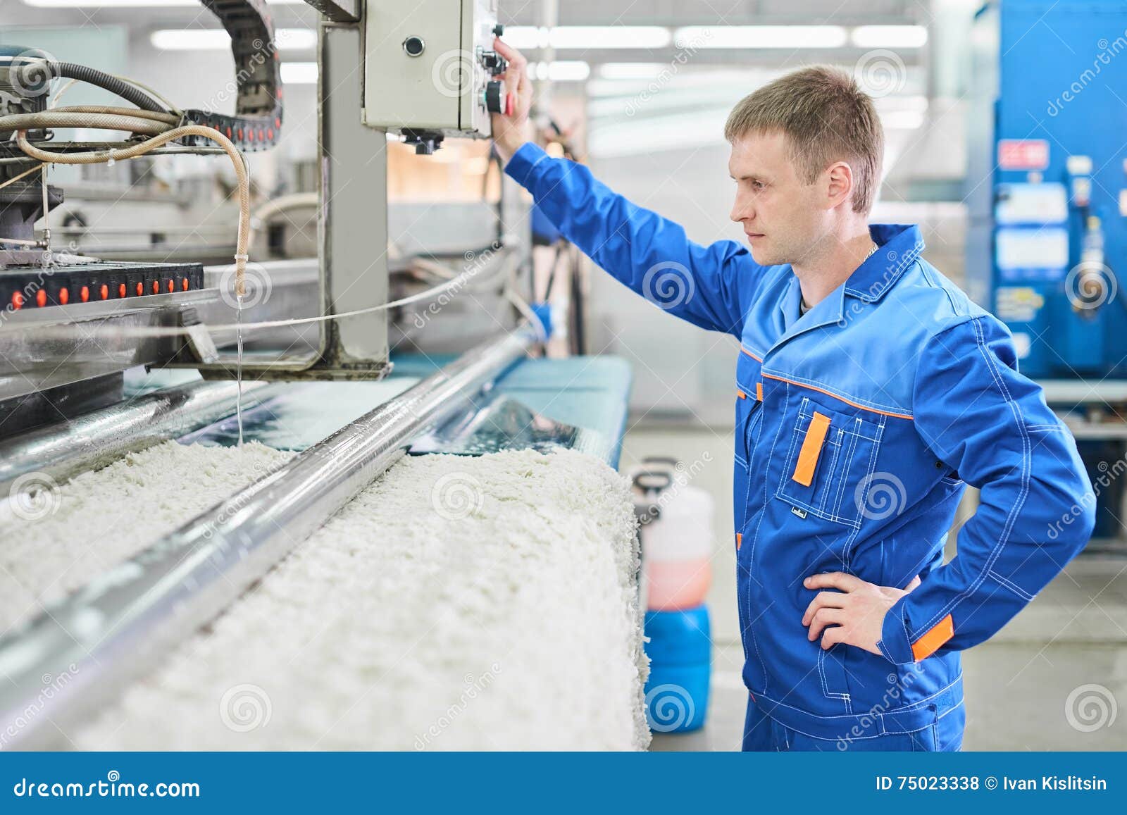 Laundry Worker In The Process Of Working On Automatic Machine For