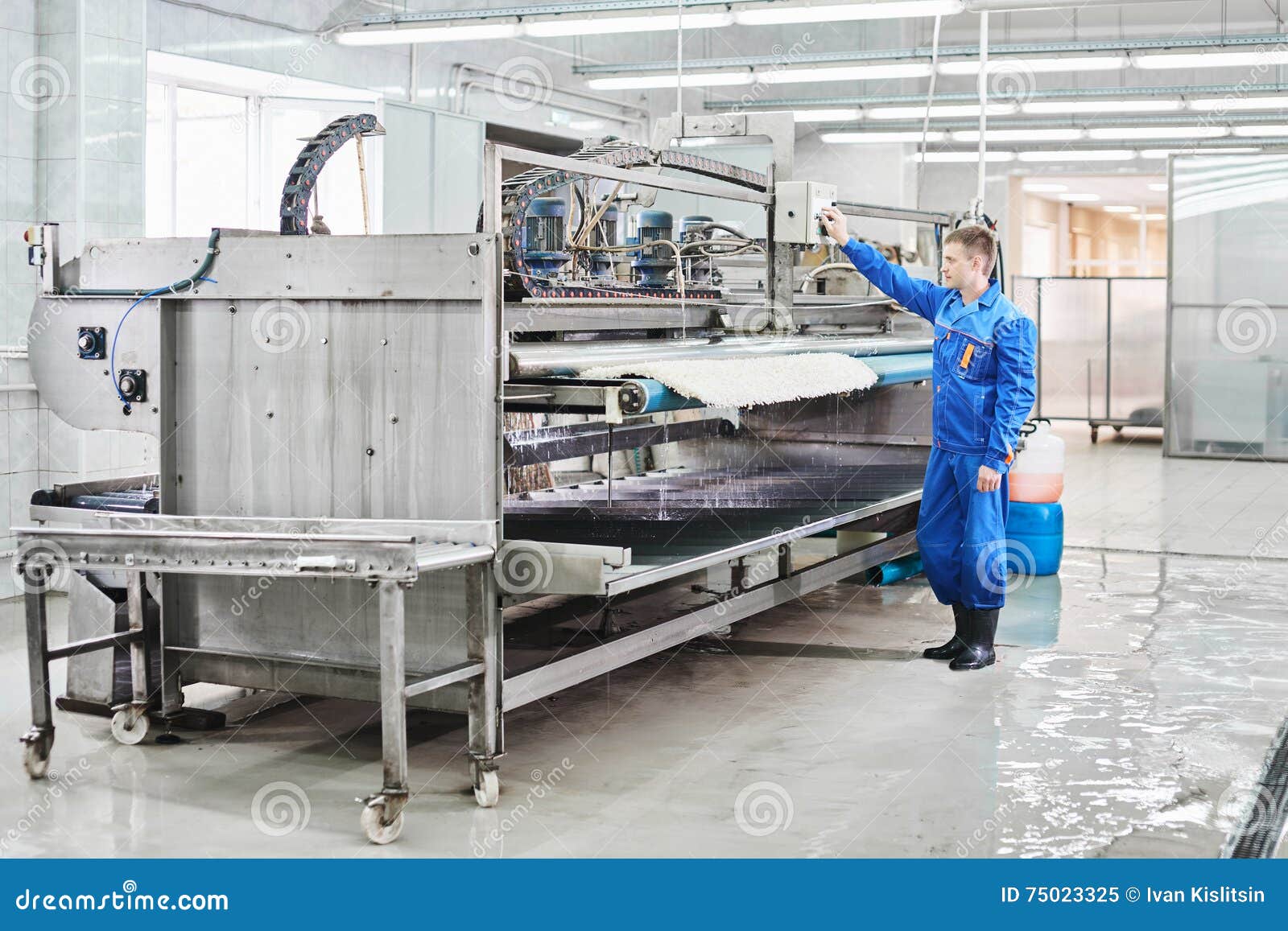 Laundry Worker in the Process of Working on Automatic Machine for