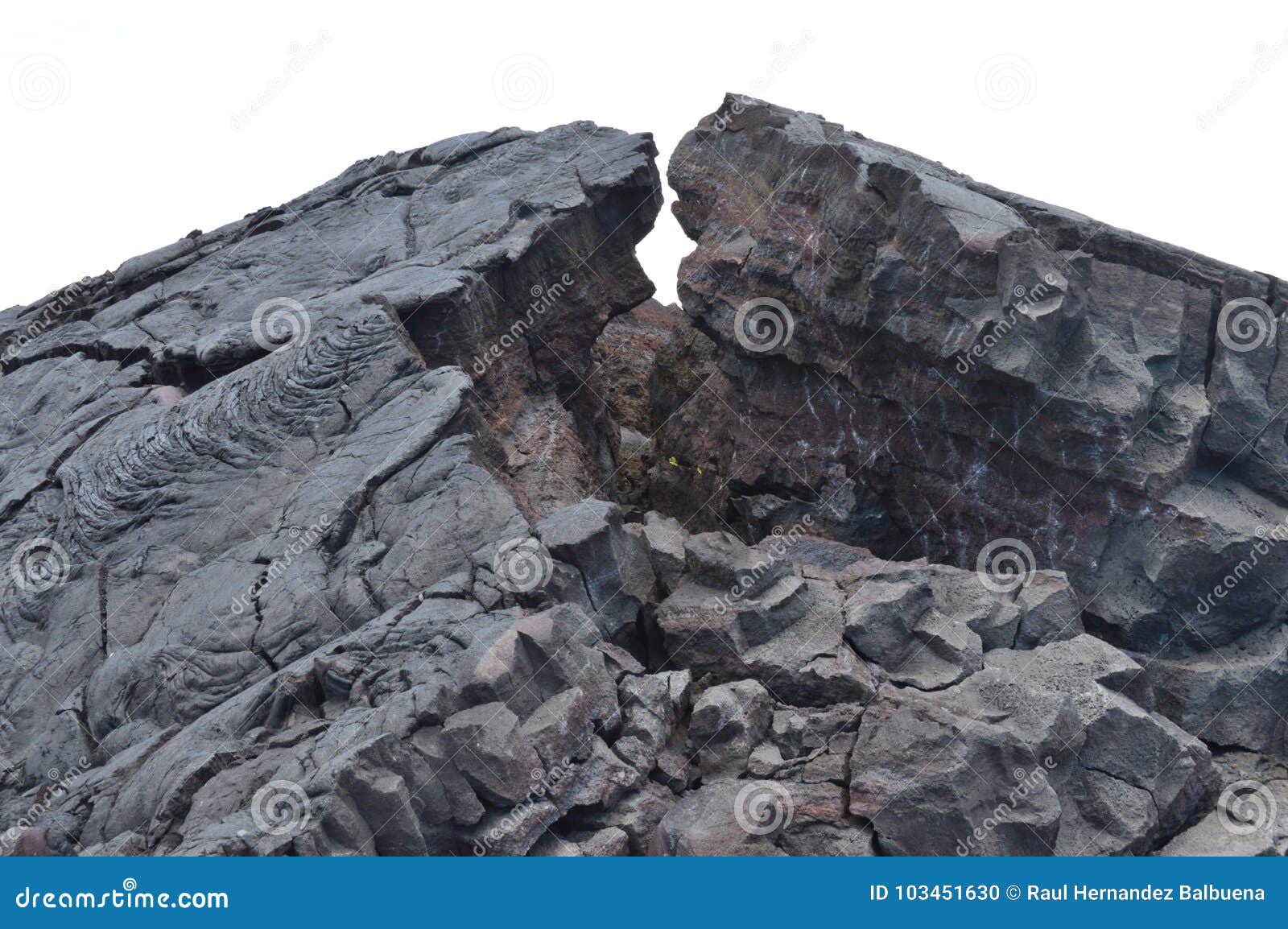 lava rocks next to erupting volcano.