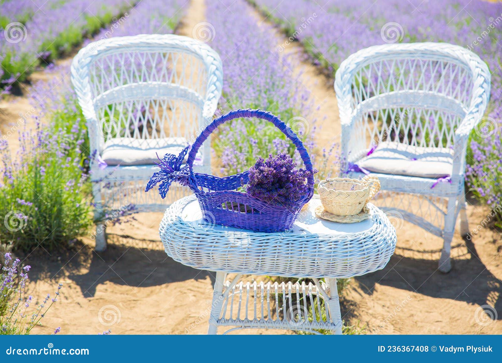 Wicker Chair And Baskets With Fresh And Dry Lavender Flowers In The Room  Next To It Is A Table With Vases And Candles Romantic Interior Of The Room  Tinted Photo High-Res Stock