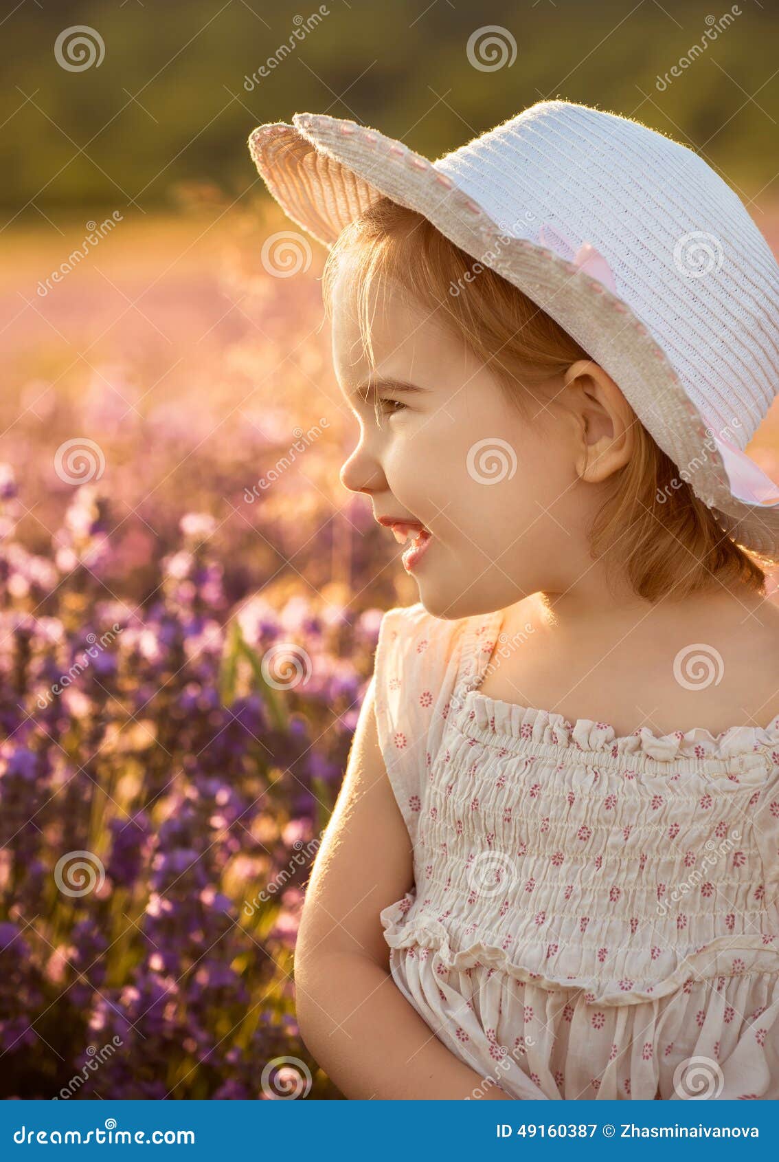 Lavender girl. Beautiful little girl on the background of a lavender field at sunset