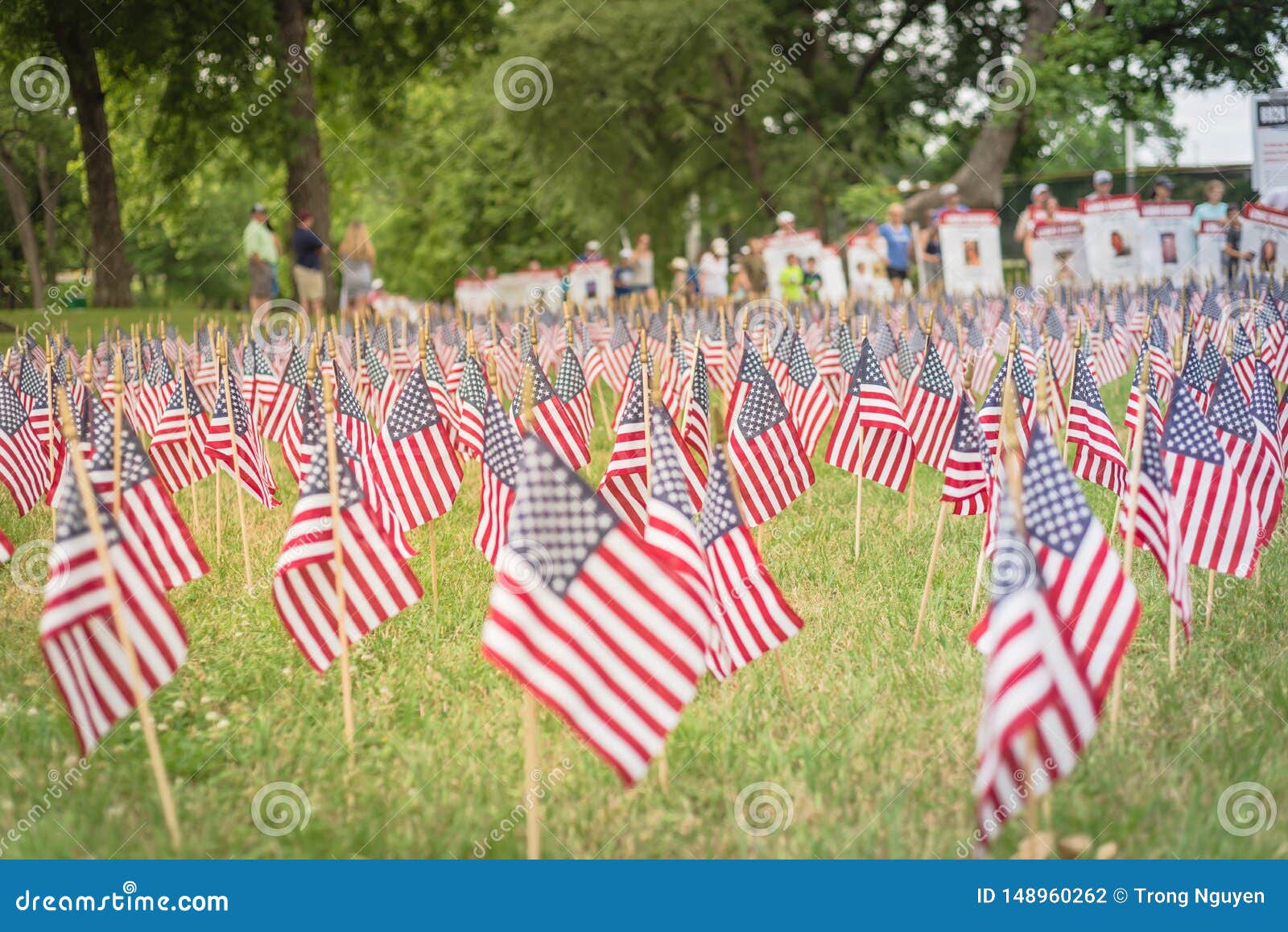 Lawn American Flags With Blurry Row Of People Carry Fallen Soldiers