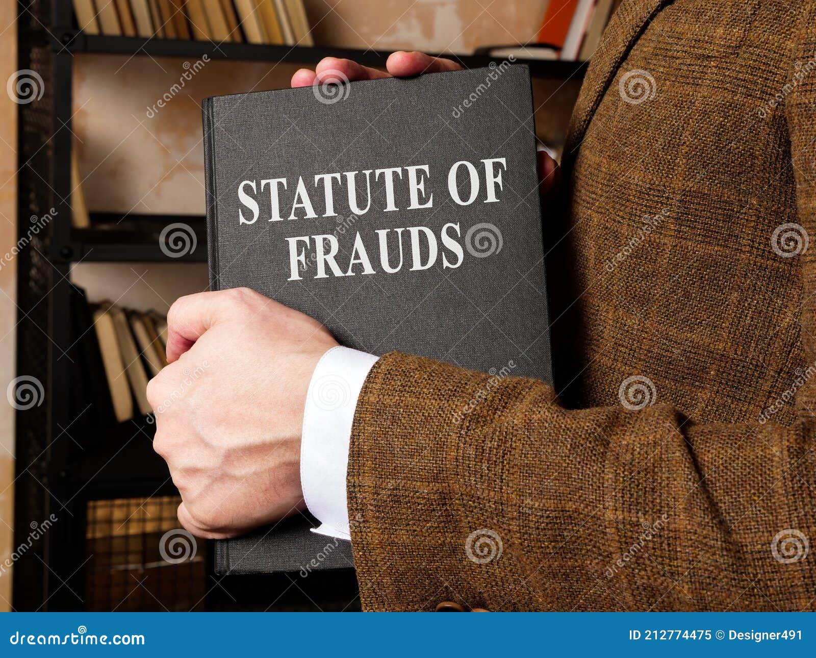 lawyer takes a statute of frauds book from the shelf.