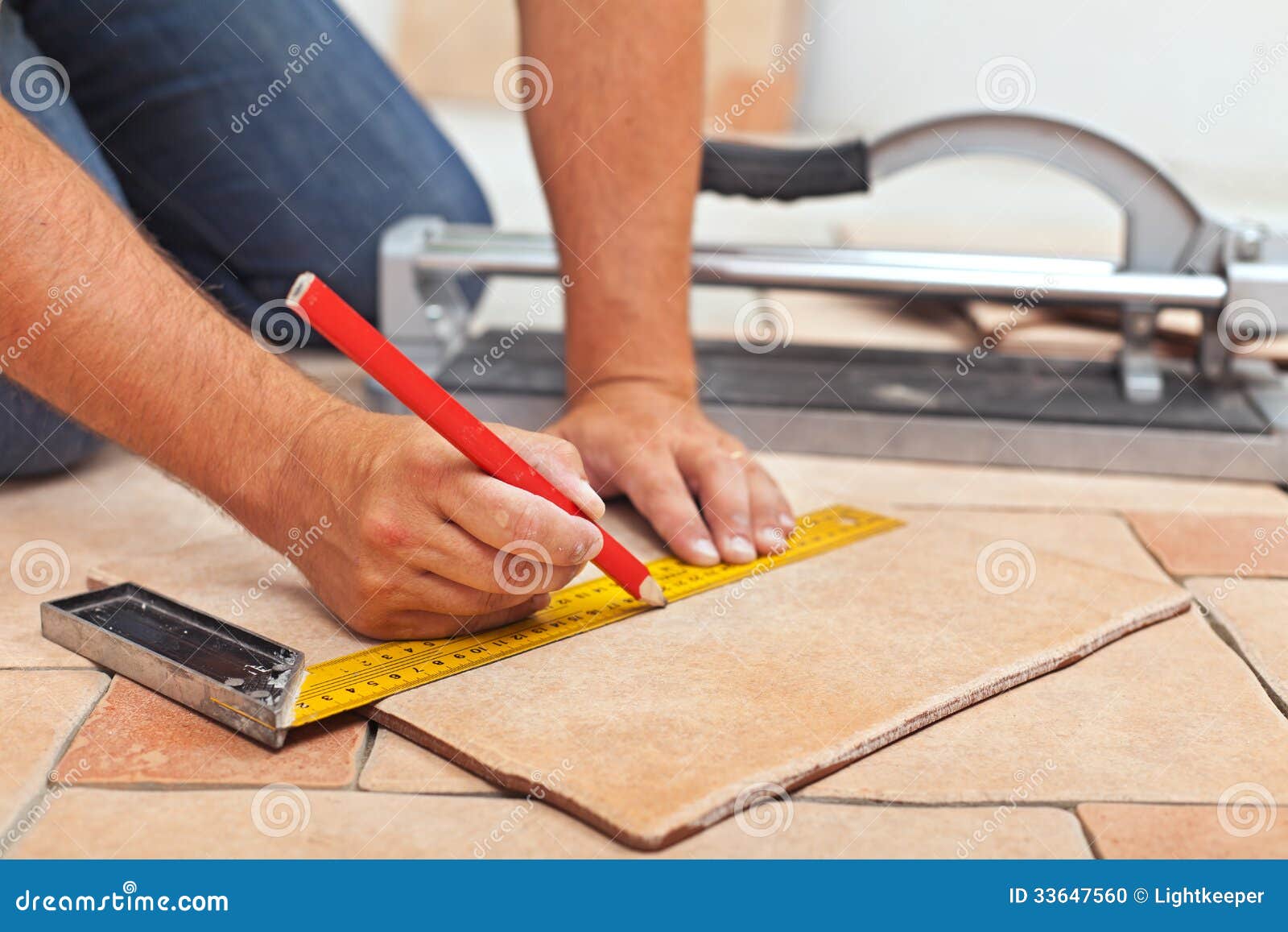 laying ceramic floor tiles - man hands closeup