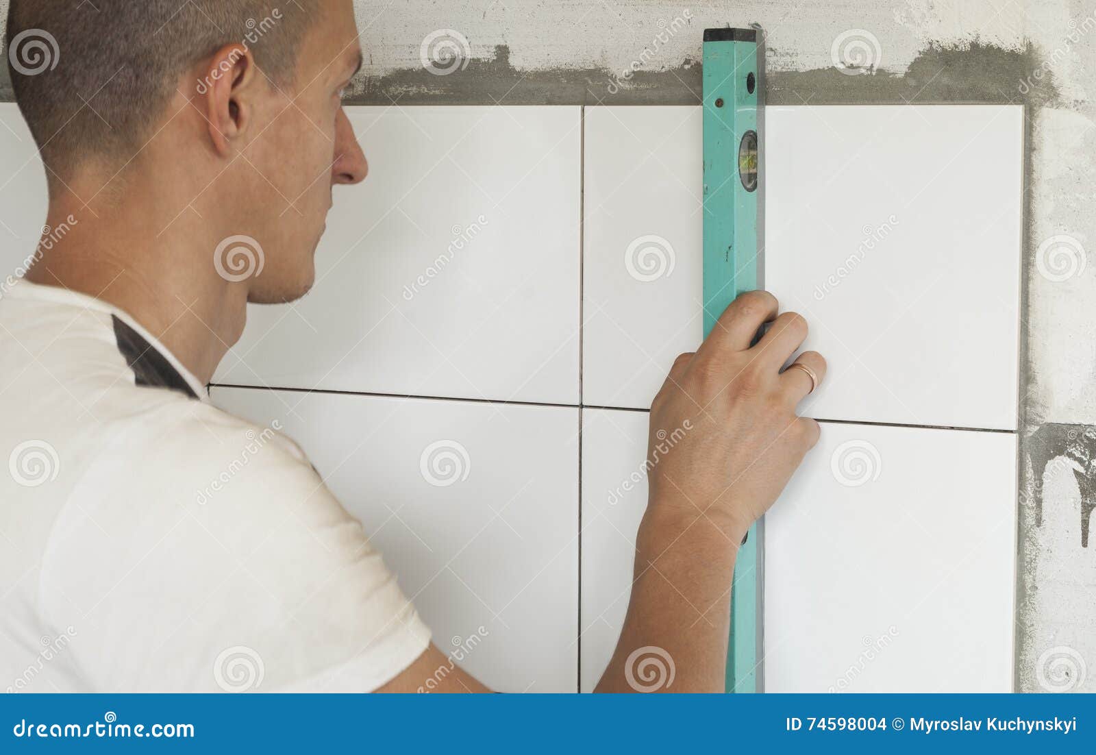 Laying ceramic tiles stock photo. Image of tiles, male 74598004