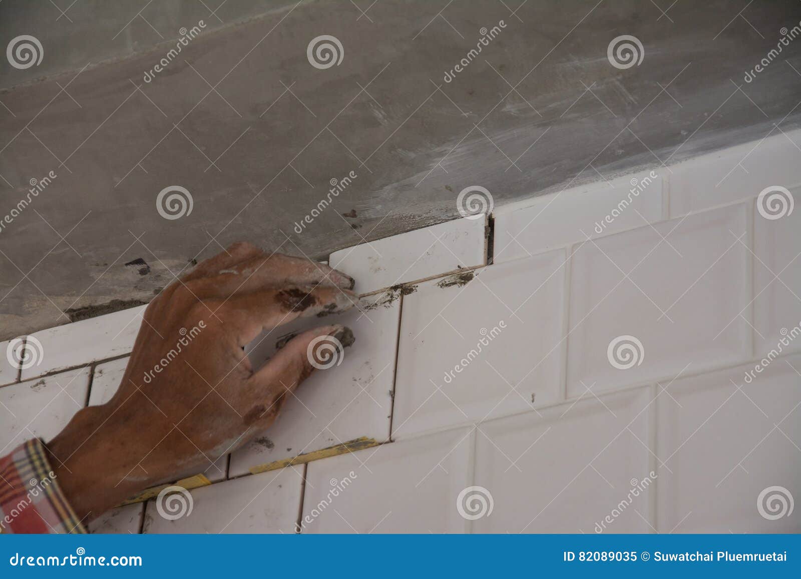 Laying Ceramic Tiles on Wall, Installing Tiles in Construction Site