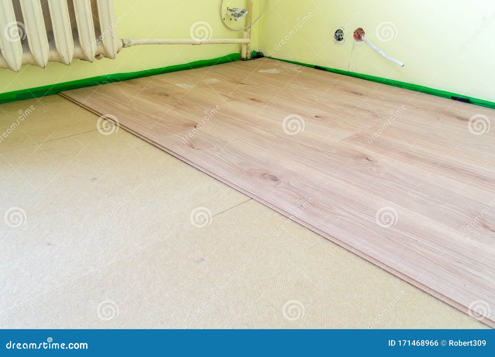 Laying Floor Panels On Chipboard Sleepers In The Room Stock Photo