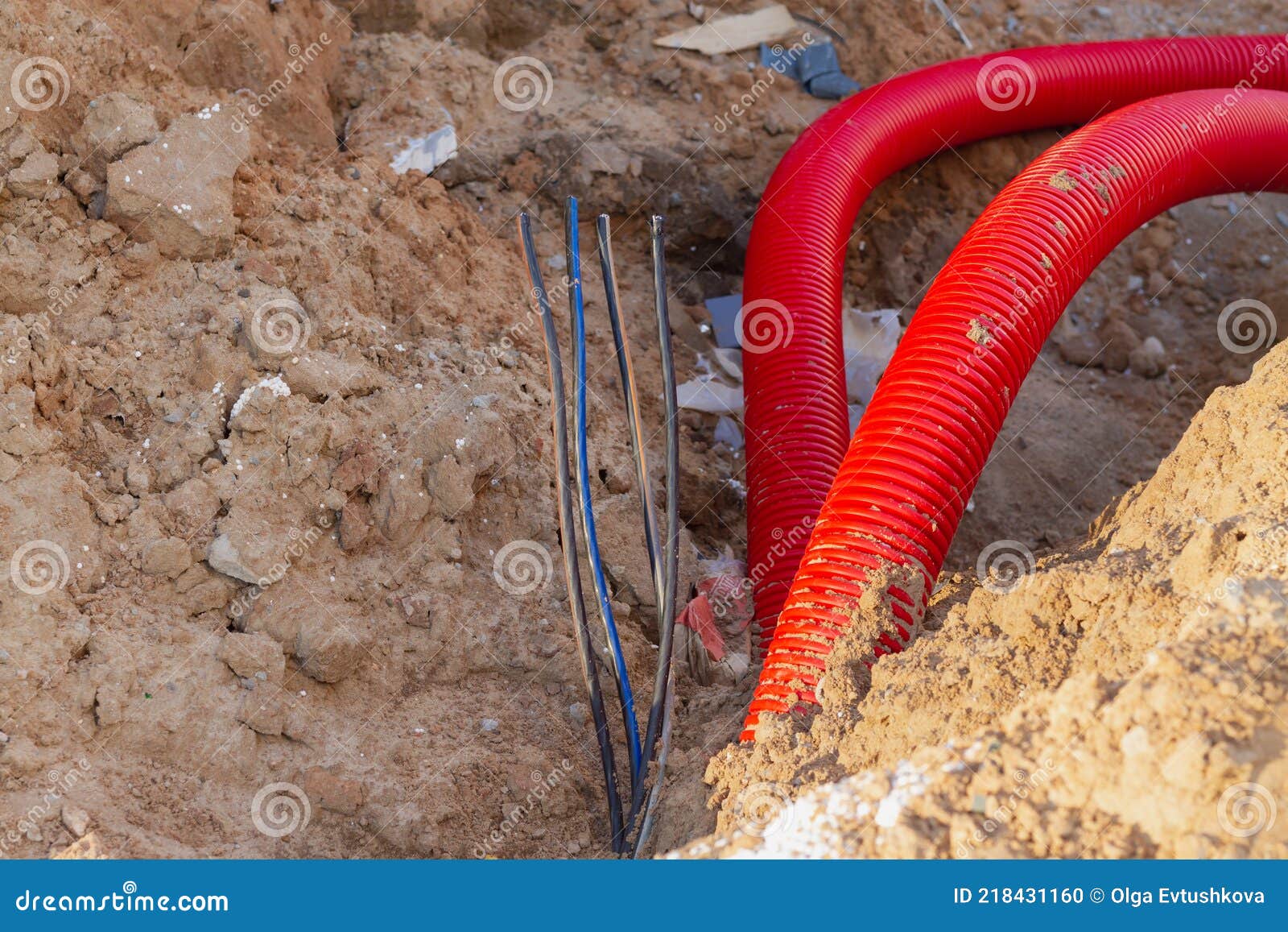Laying an Insulating Plastic Pipe with an Electric Cable Underground