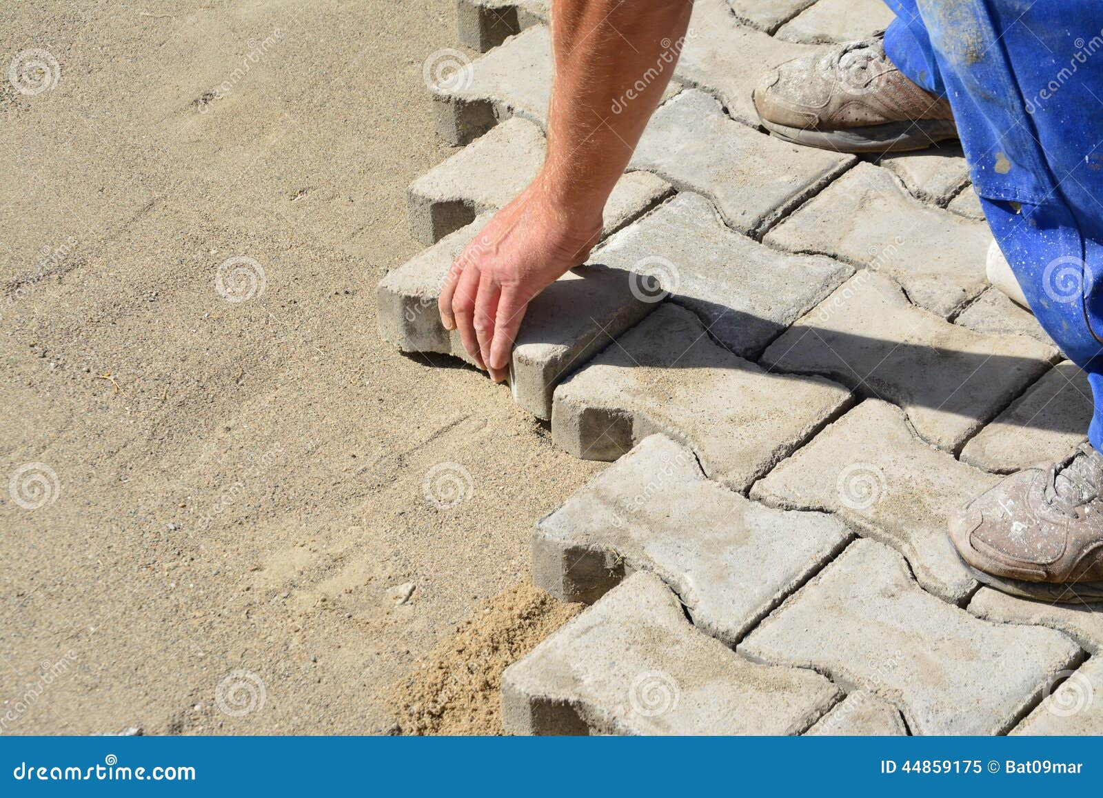 Laying interlocking pavers stock image. Image of cobble 44859175