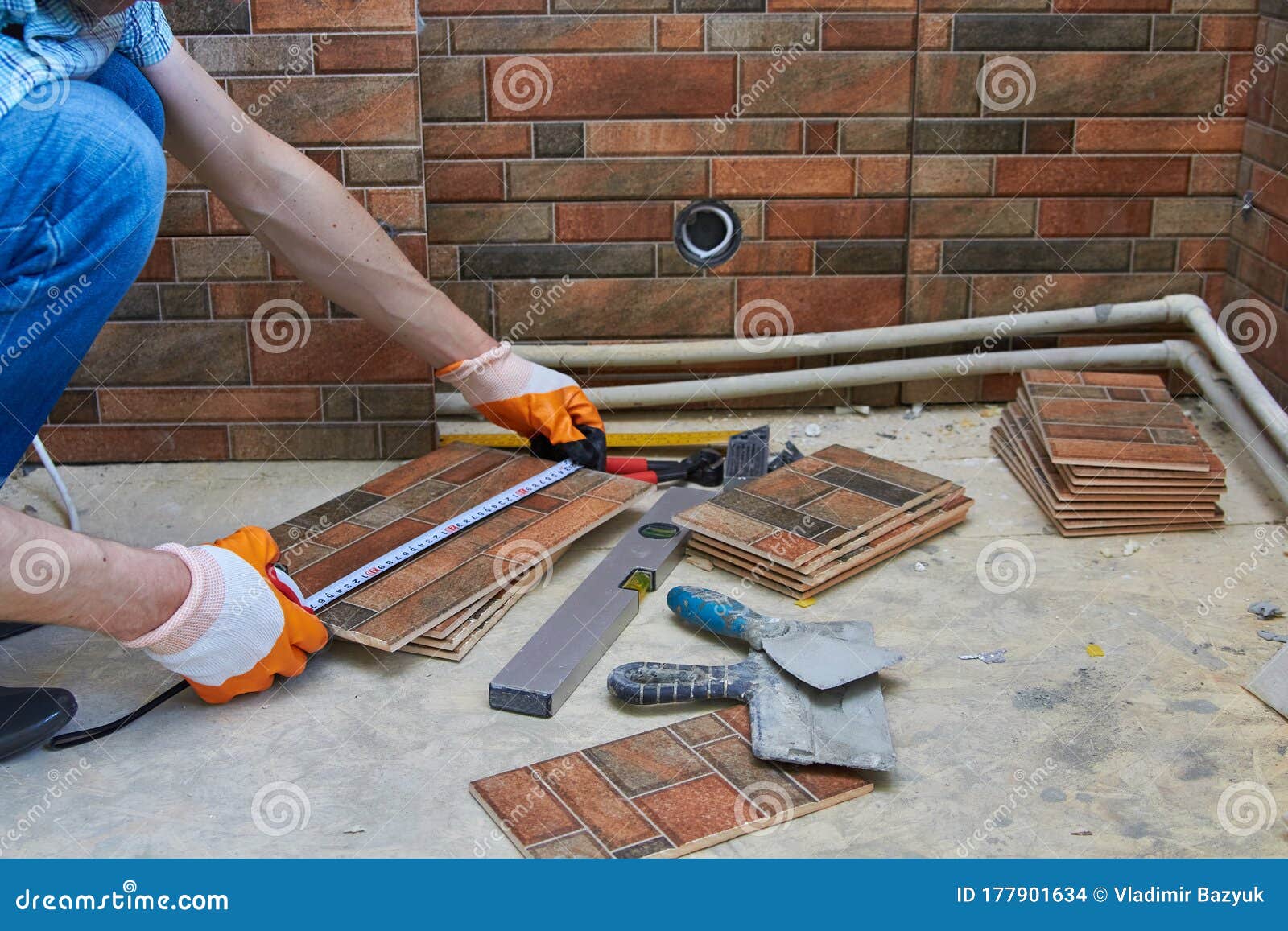 Laying Tiles in the Kitchen,working Builder in the Kitchen Measures the Tape Measure the Length