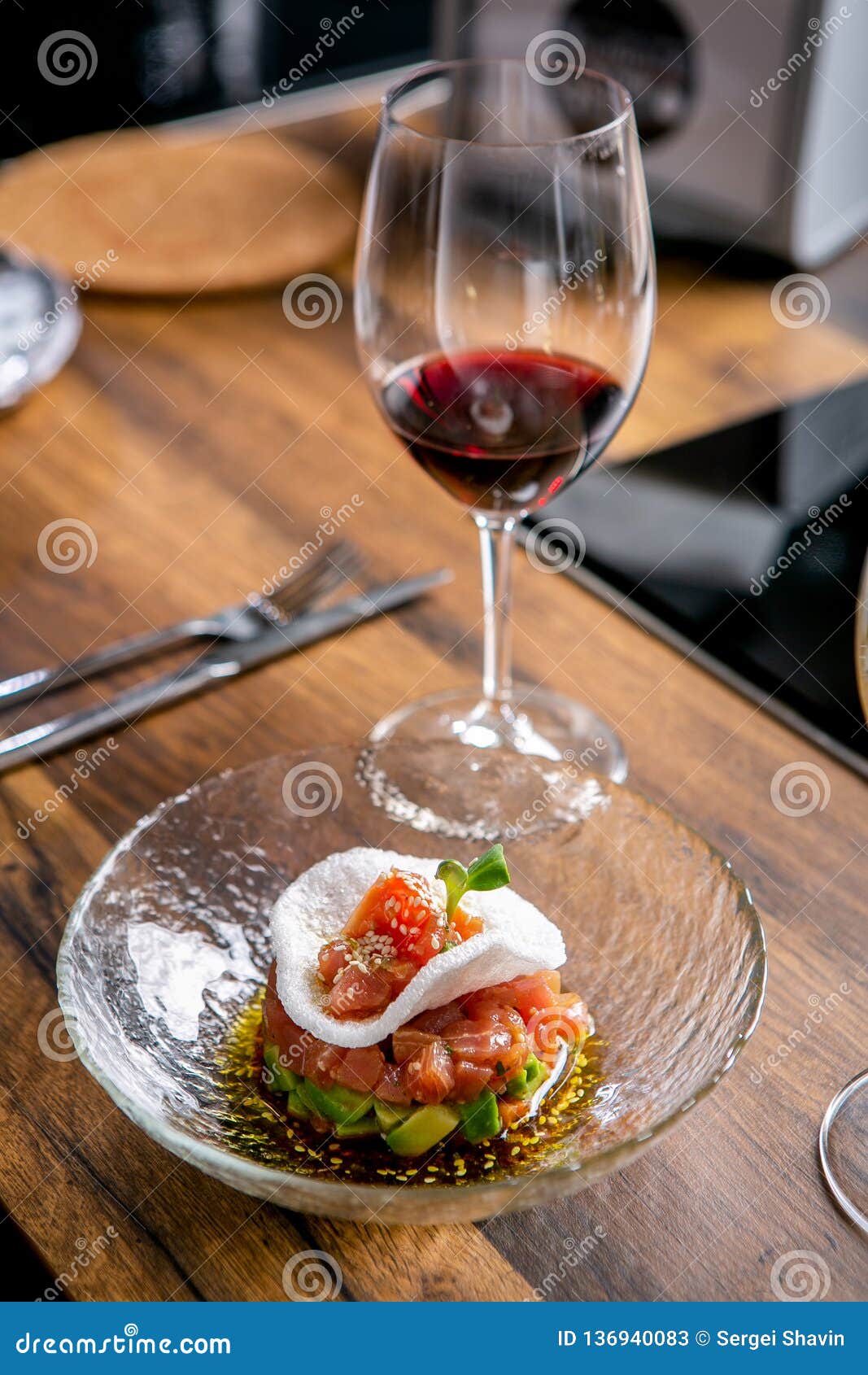 The Layout of the Finished Dish. Tuna Tartar on a Plate and a Glass of