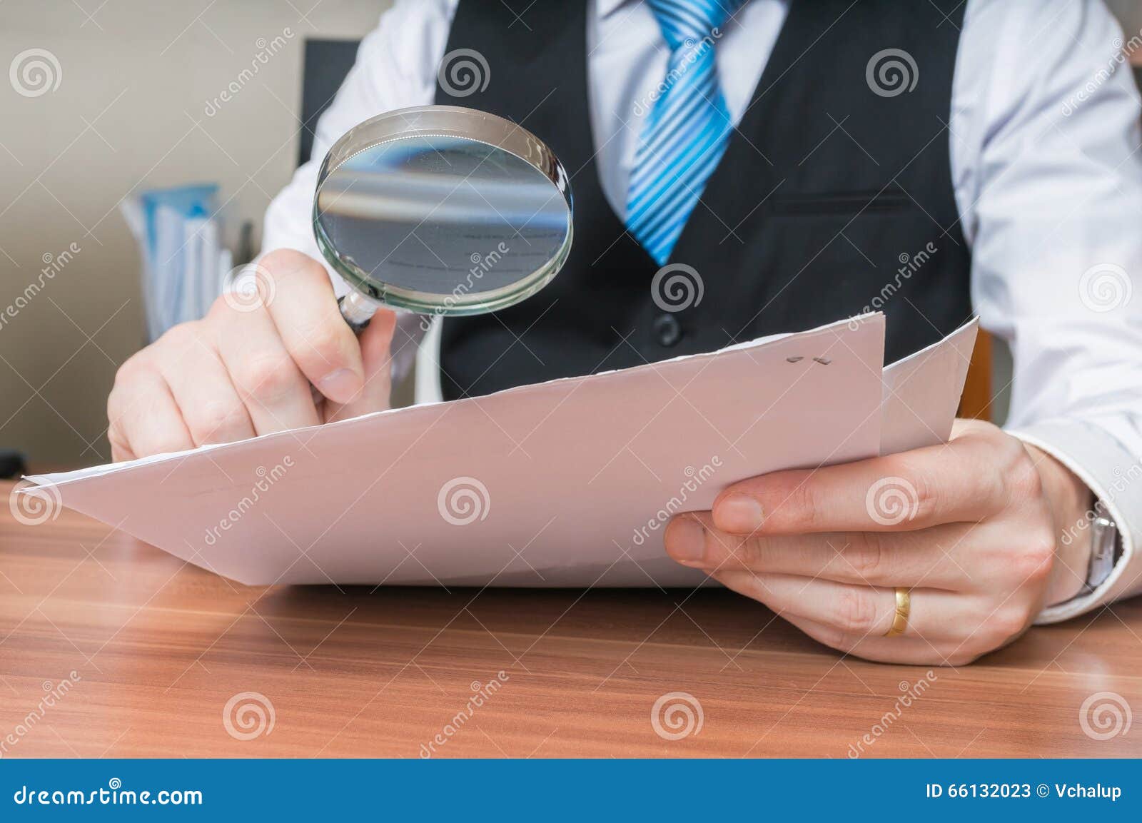 laywer is analysing document with magnifying glass