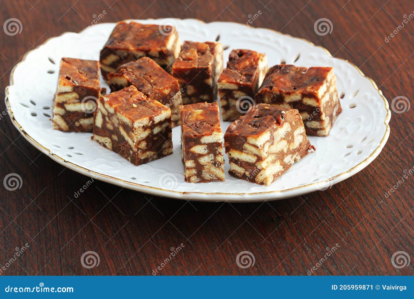 lazy cake or mosaic cake . homemade no bake chocolate biscuit cake on a wooden table