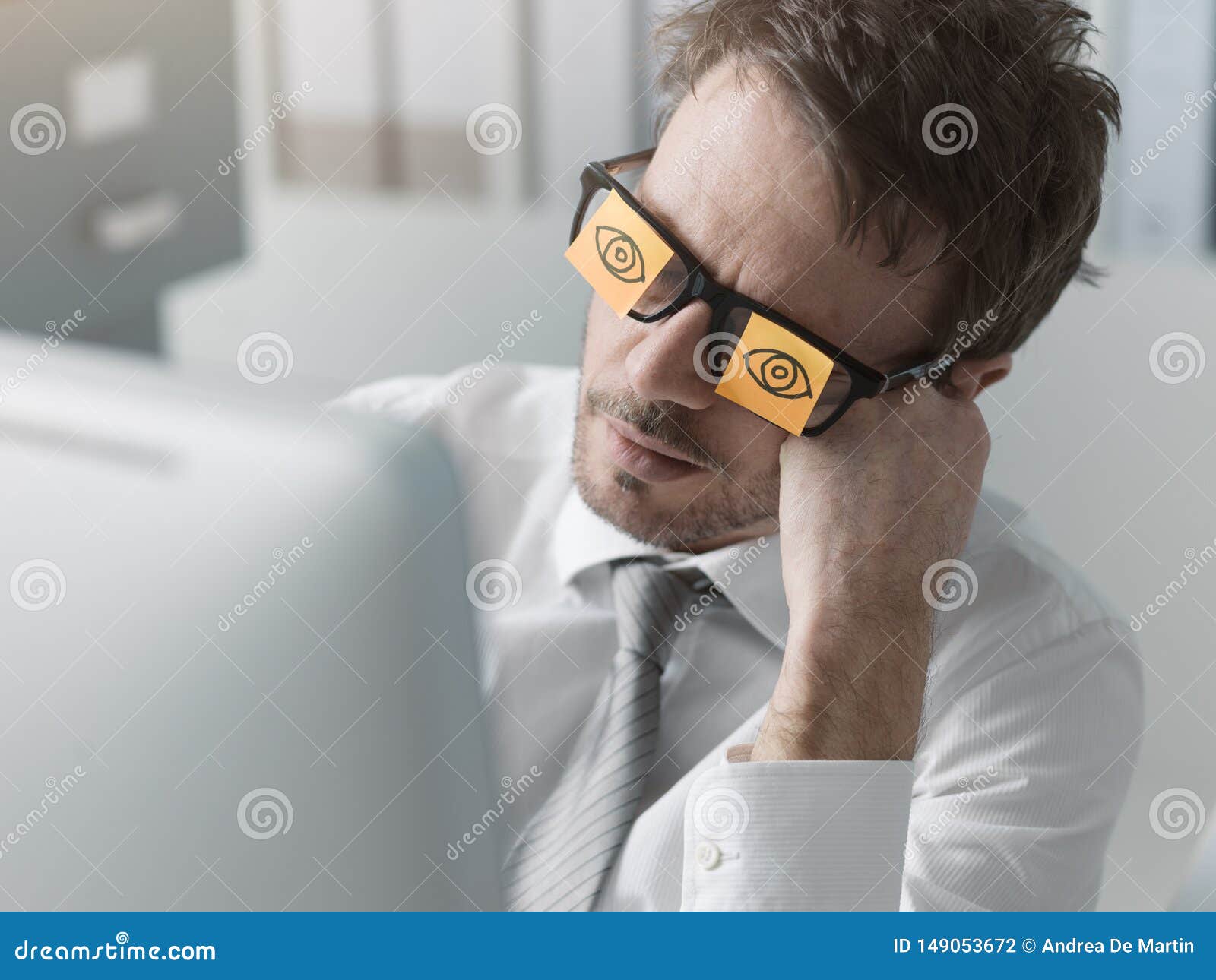 lazy office worker wearing sticky notes over his glasses