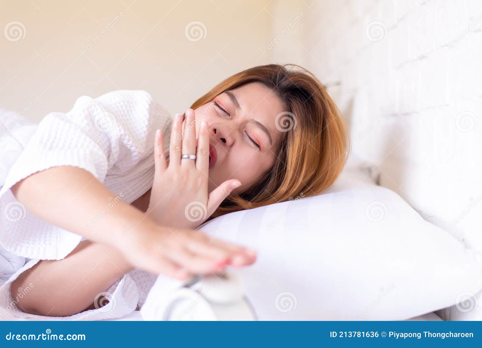 lazy woman yawning on bed and tired sleepy,female having symptoms sleepiness