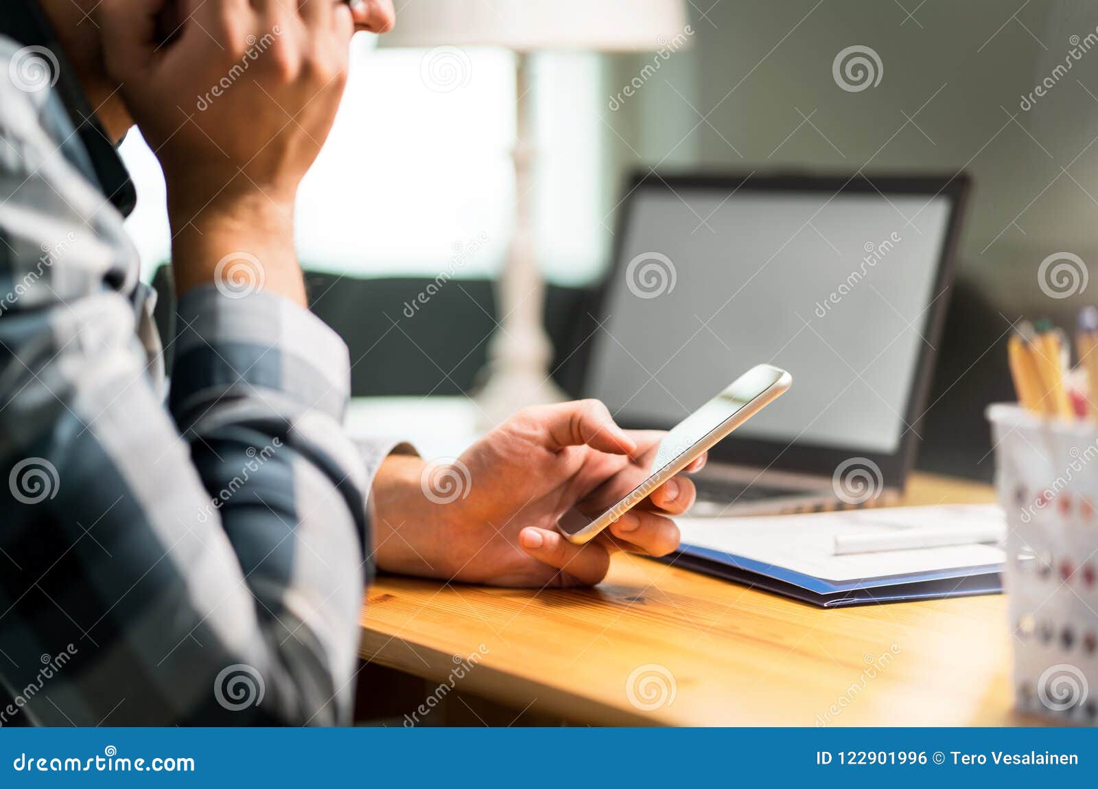 lazy worker using phone in office avoiding work