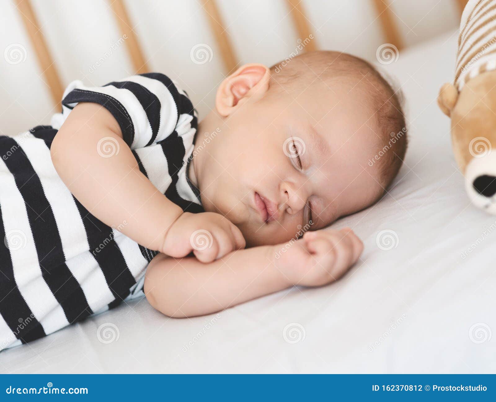 Le Nouveau Ne En Train De Dormir Sur Son Cote Dans Un Lit D Enfant Closeuse Photo Stock Image Du Mort Cheri