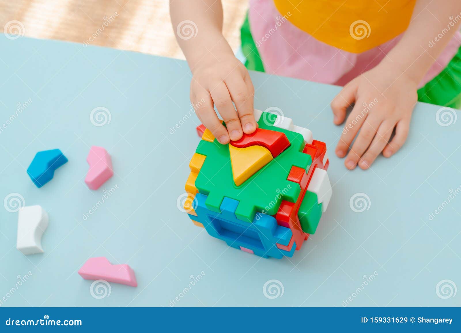 Le Rapprochement Des Mains De L'enfant Ramasse Le Trieur De Puzzle