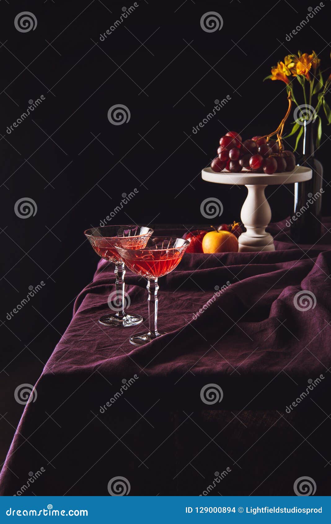 Lead Glasses of Wine Stand with Grapes and Apples on Table with Drapery